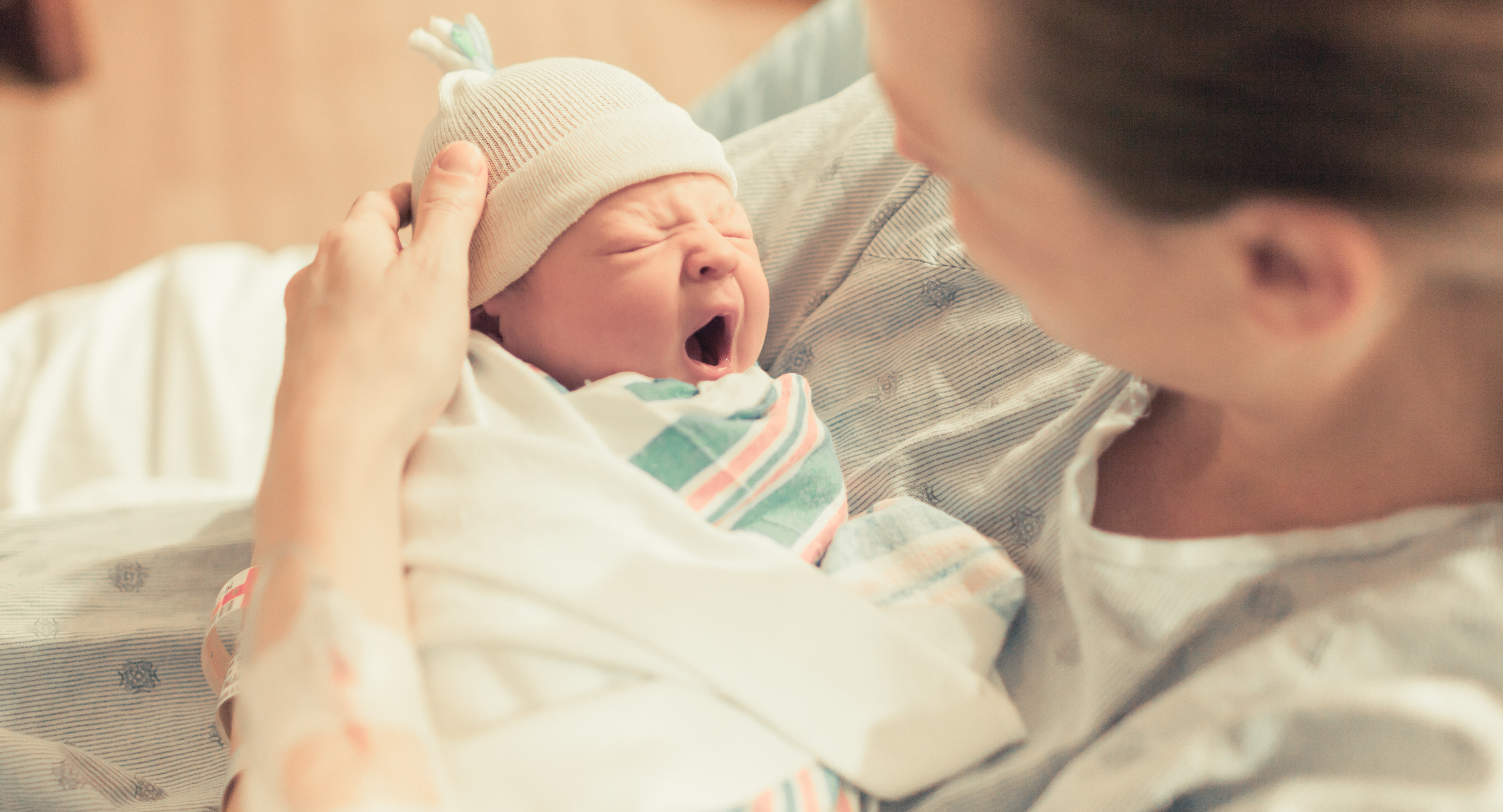 Mother in hospital holding her new born baby