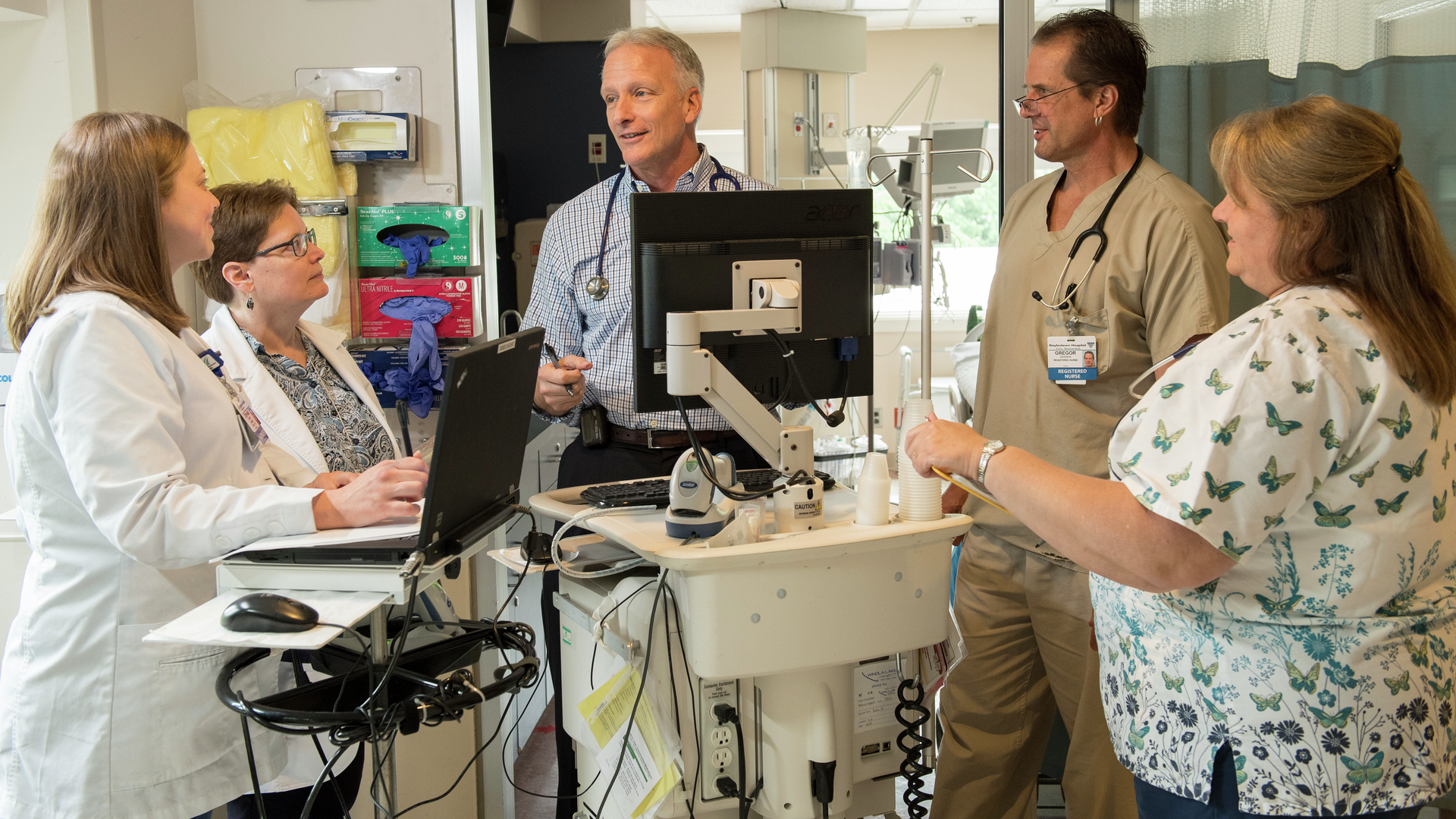 Male and female providers discussing a health topic in a hospital area
