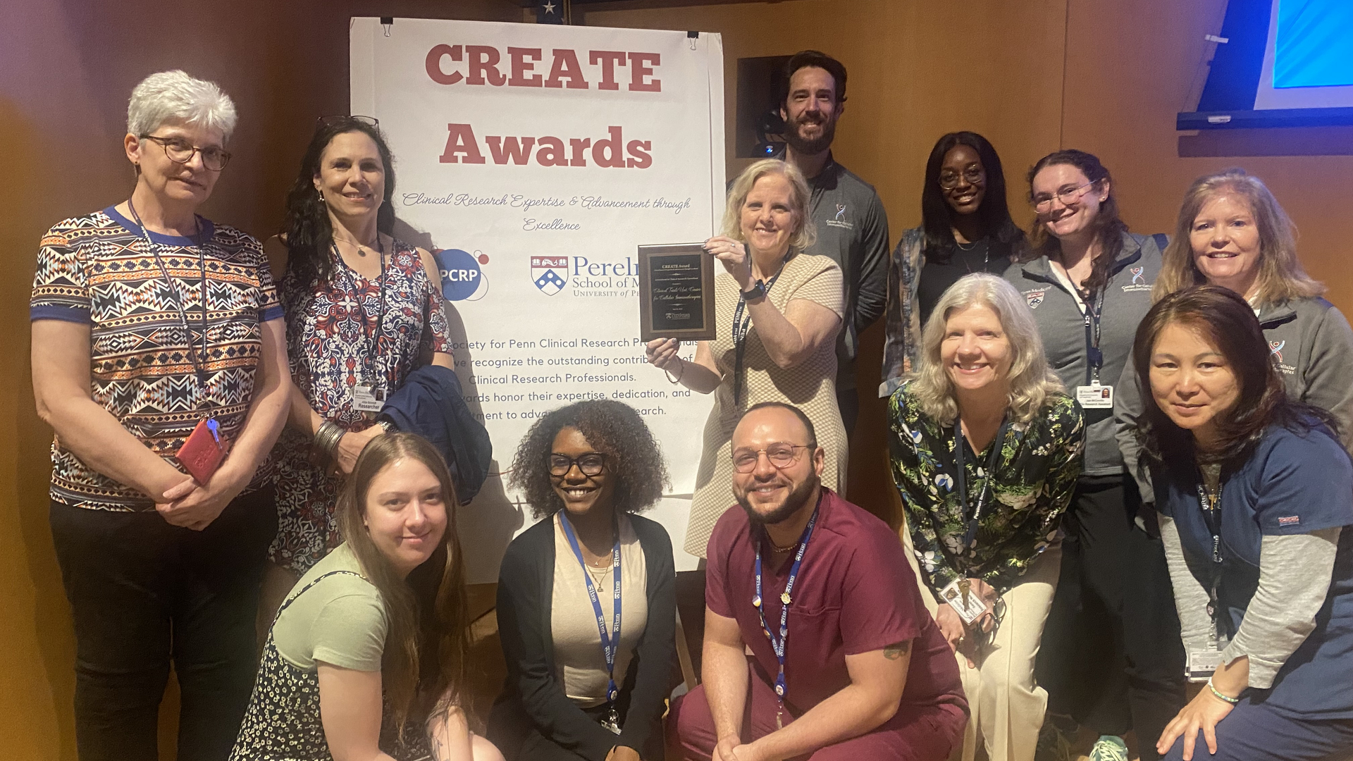 Group photo of the CTU team with their plaque in front of a sign for the CREATE awards