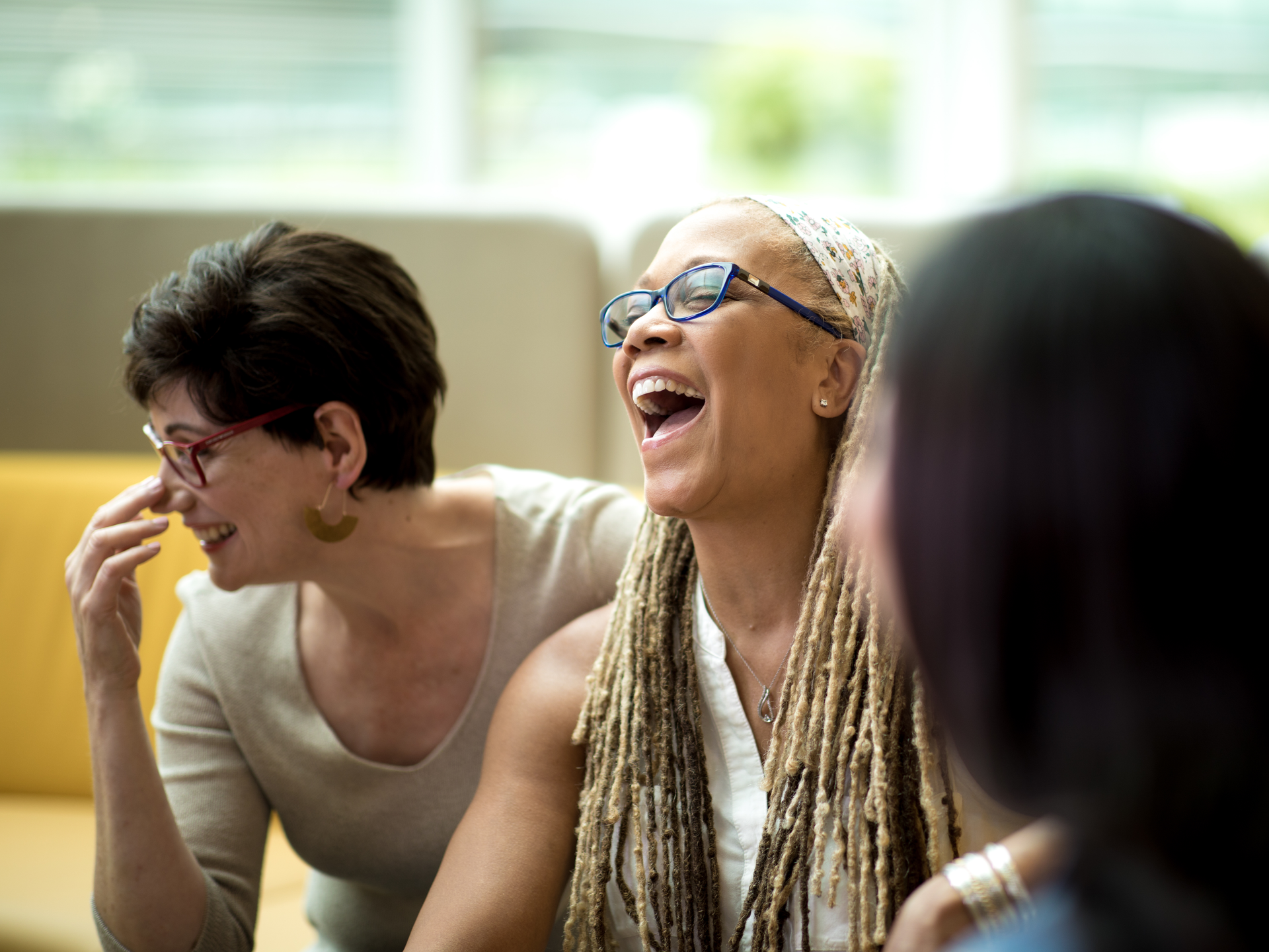 Group of Penn Medicine Women's Health patients laugh together on a bench