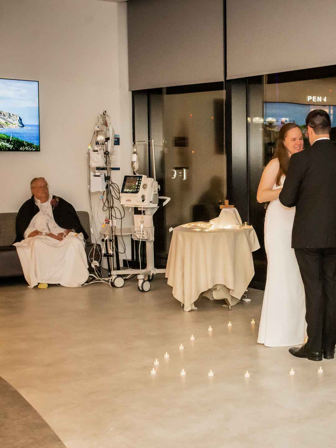 Patient Keith Maggs looks on as his son, Andrew, and future daughter-in-law say their vows on the cardiac intensive care unit