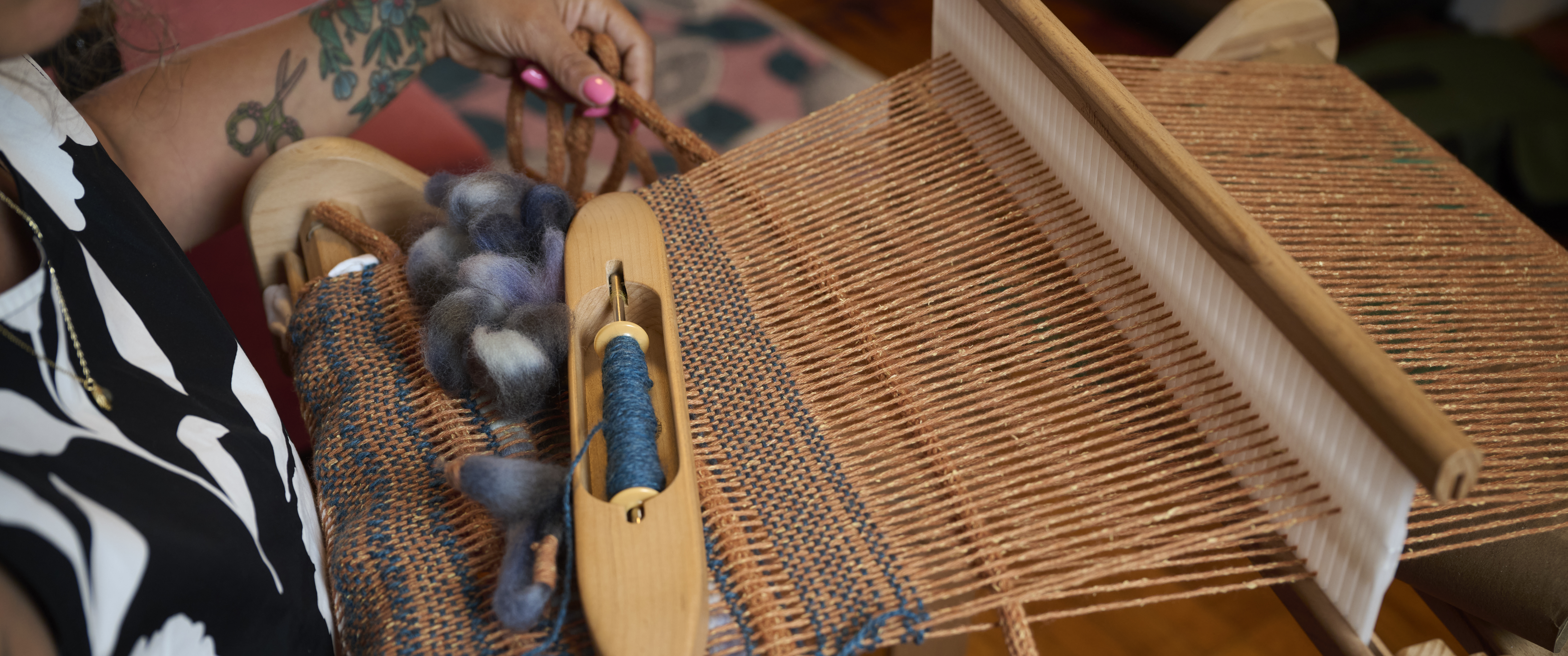 Linda Ruggiero weaving at a loom