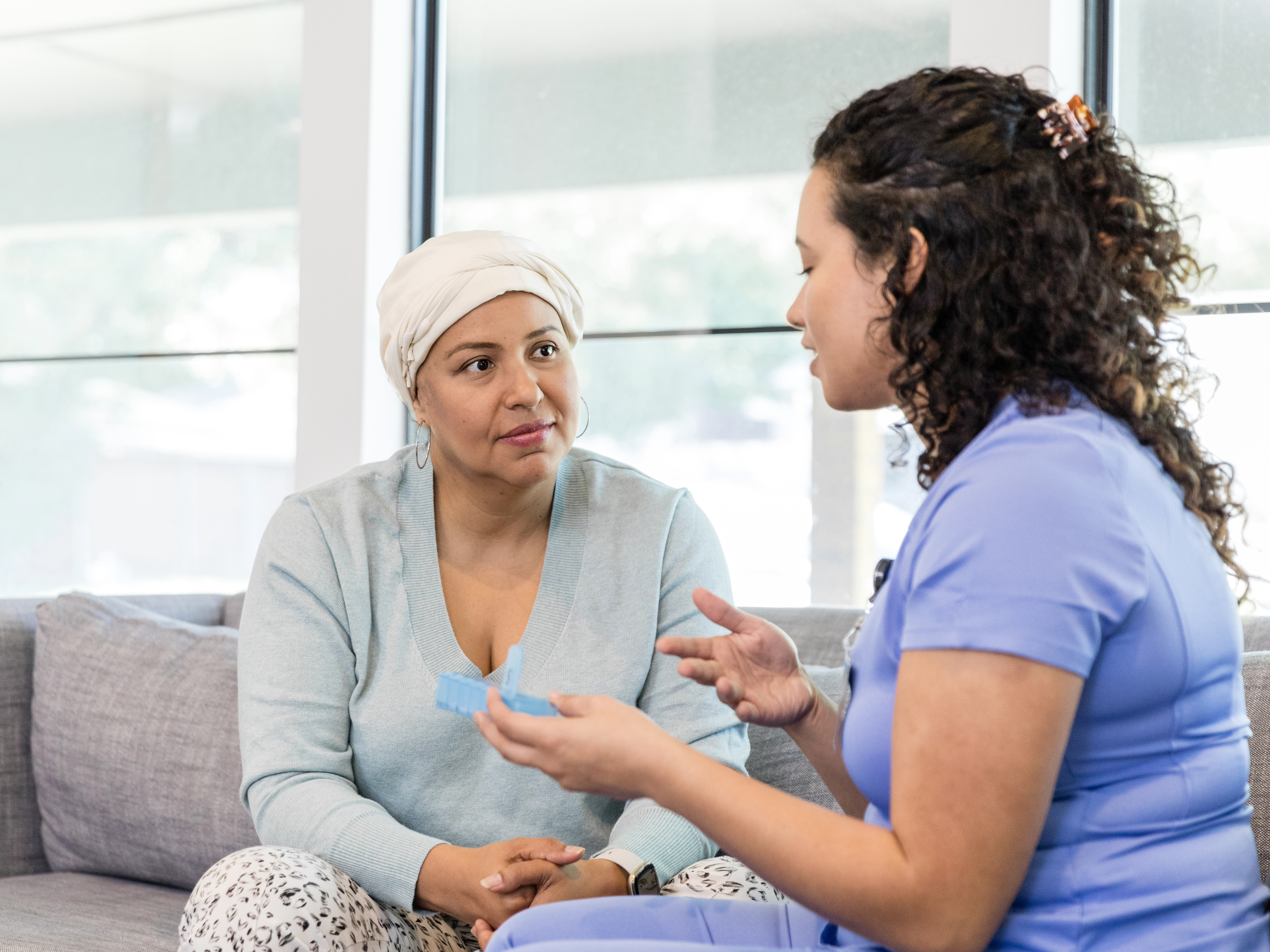 Female nurse explains to patient how to keep track of the medication
