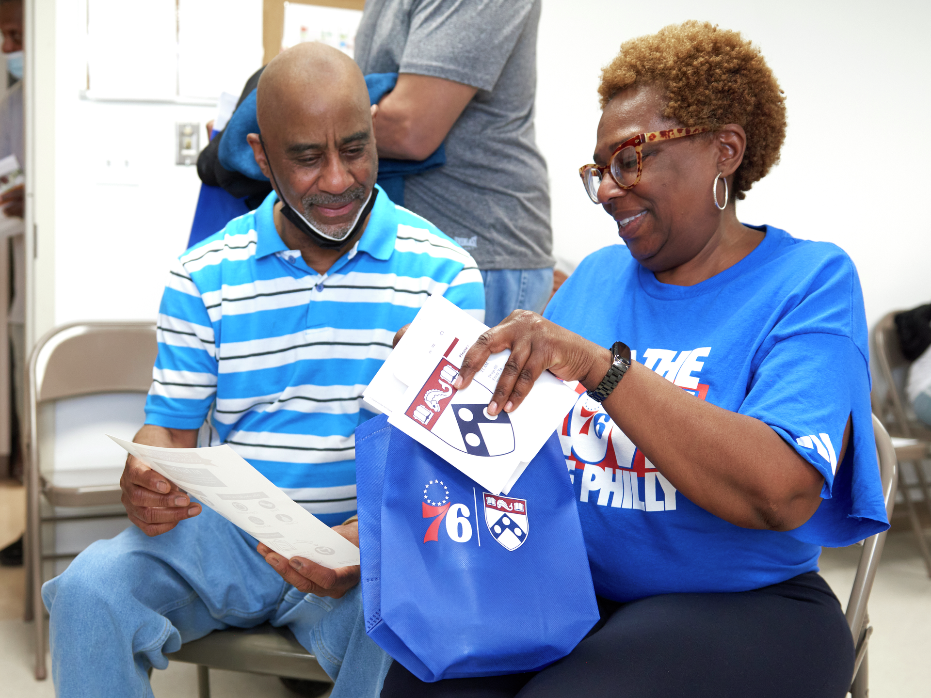 Theo Matlock with Armenta Washington discussing a colorectal cancer screening kit