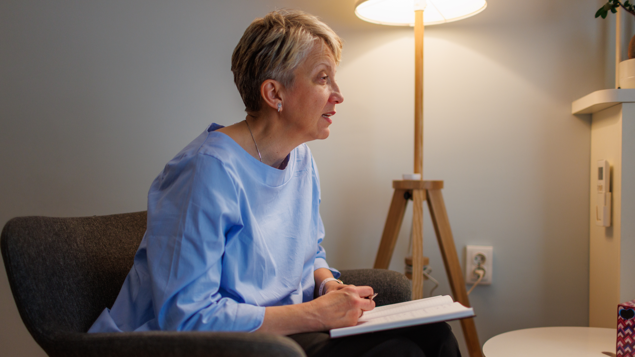  A female psychologist talking with a patient in her office.