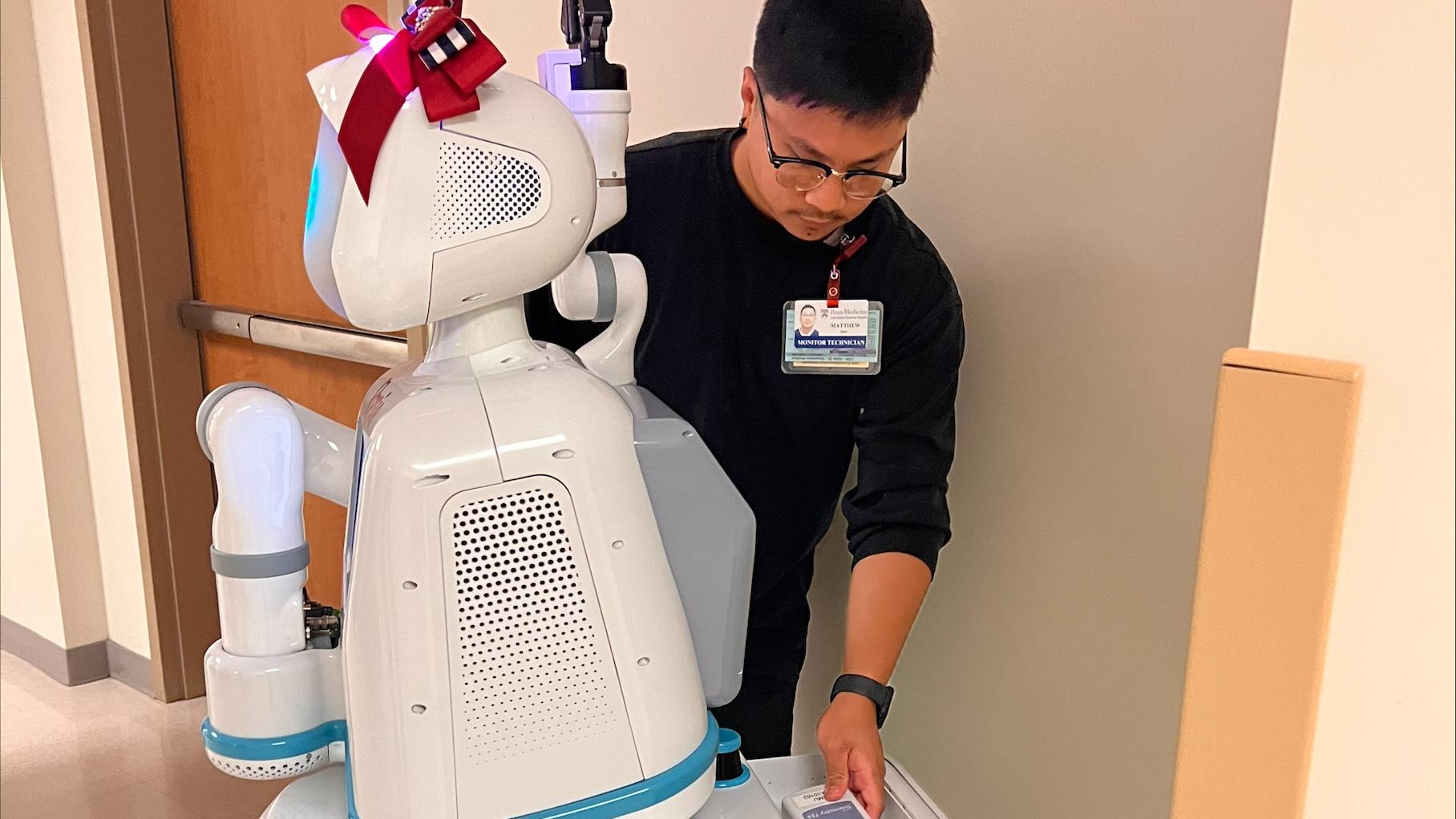  Registered nurse Justin Gavaghan working with robotic nursing assistant