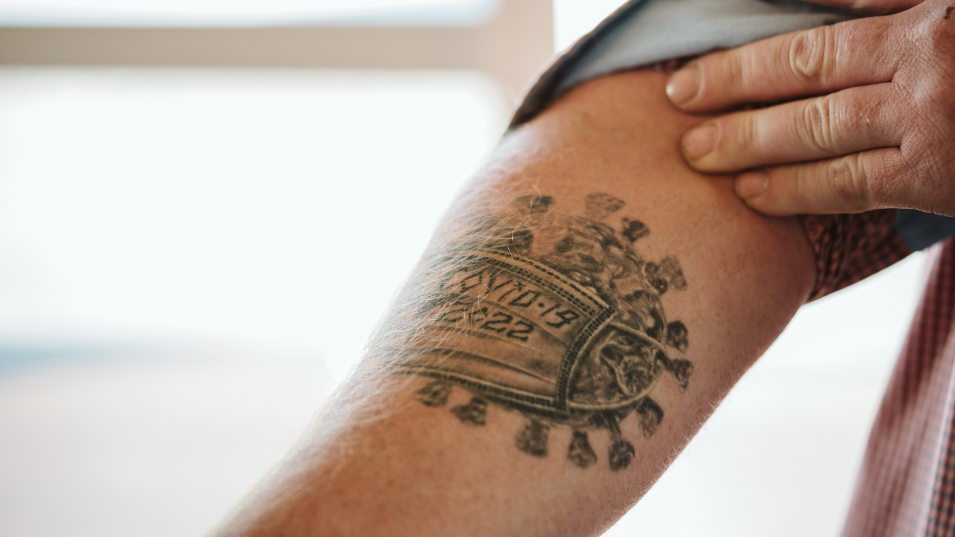 A tattoo of the COVID virus
