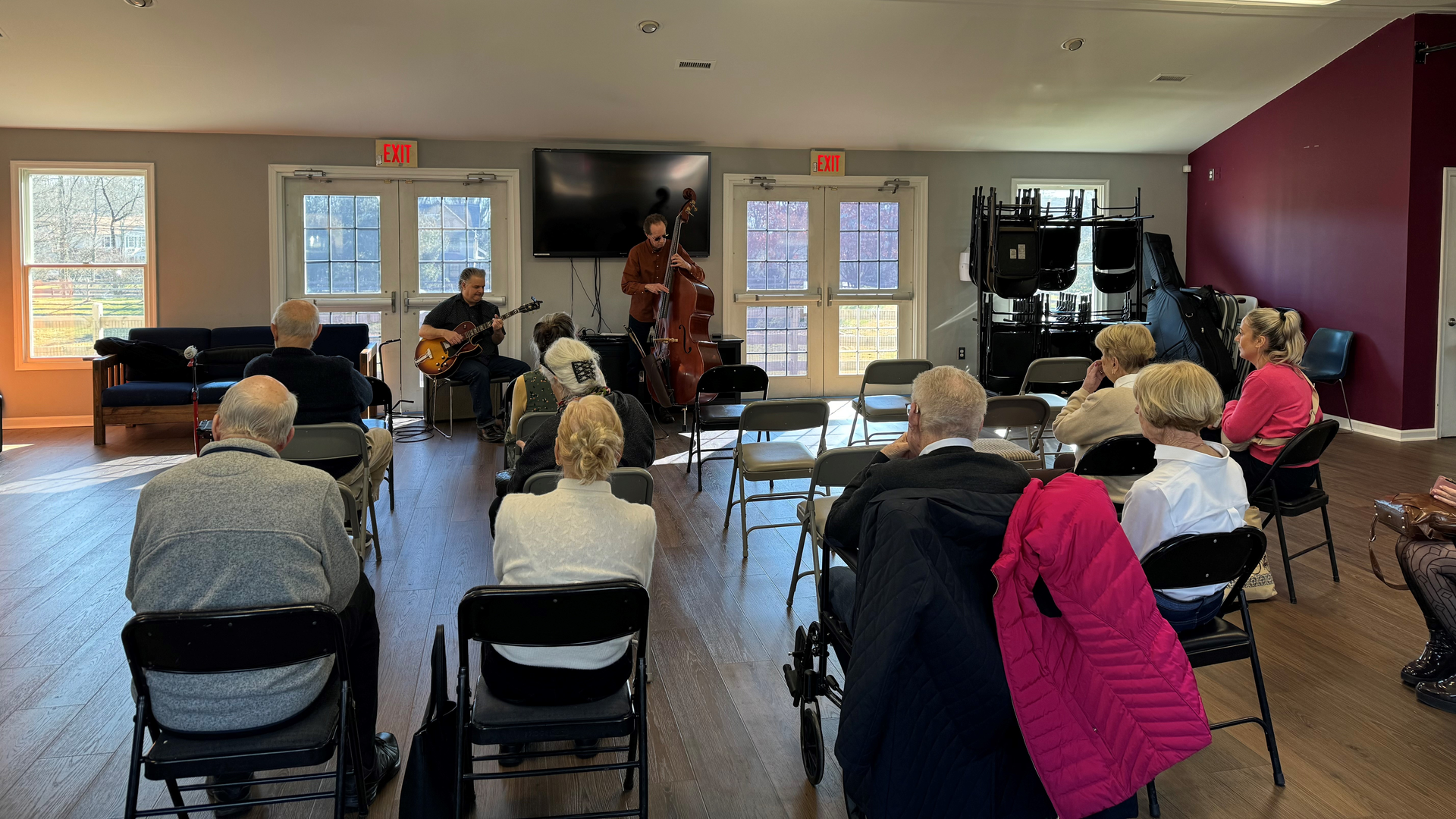 Community program attendees listening to musicians