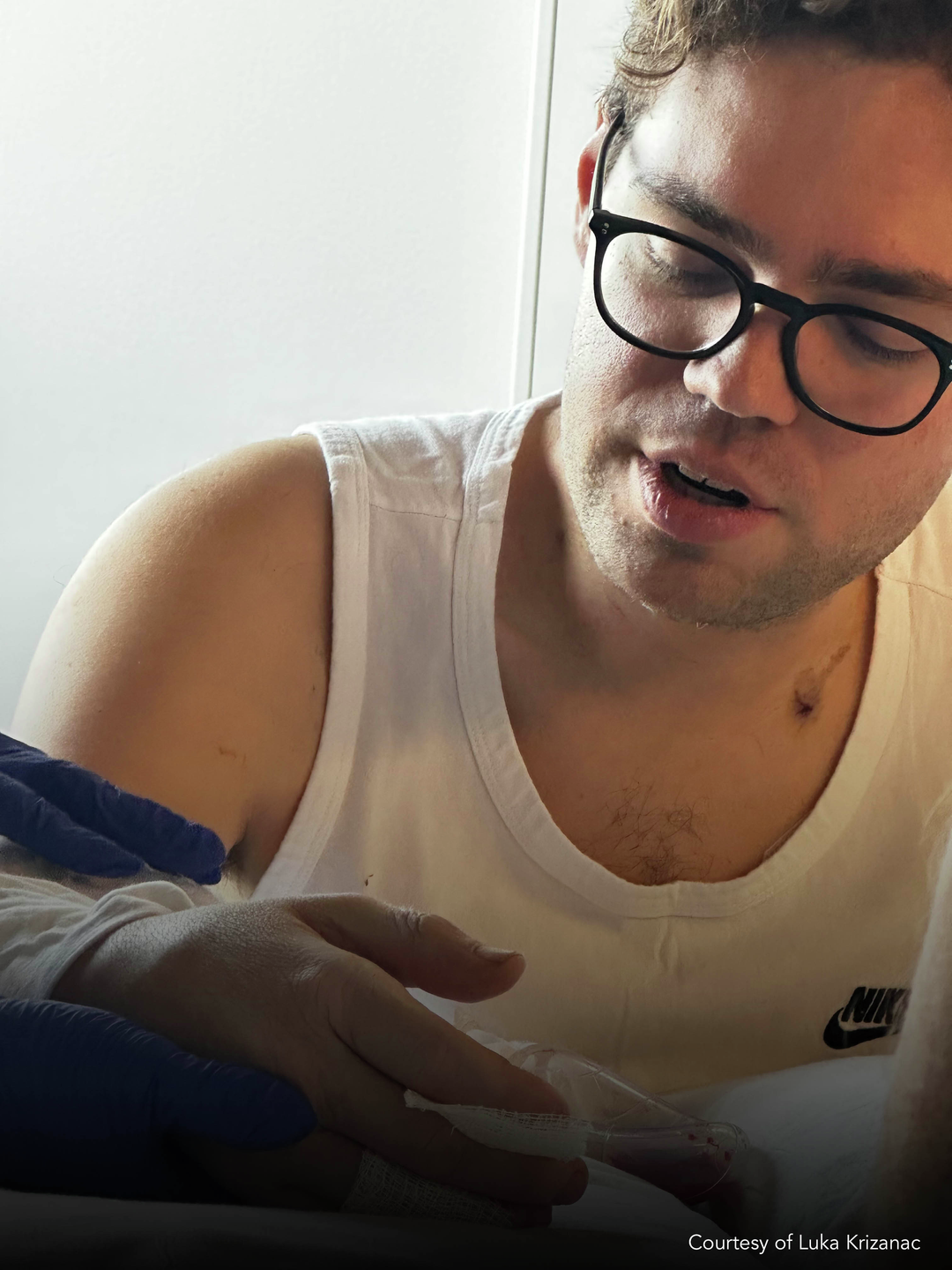 Luka Krizanac sitting and looking at his right hand