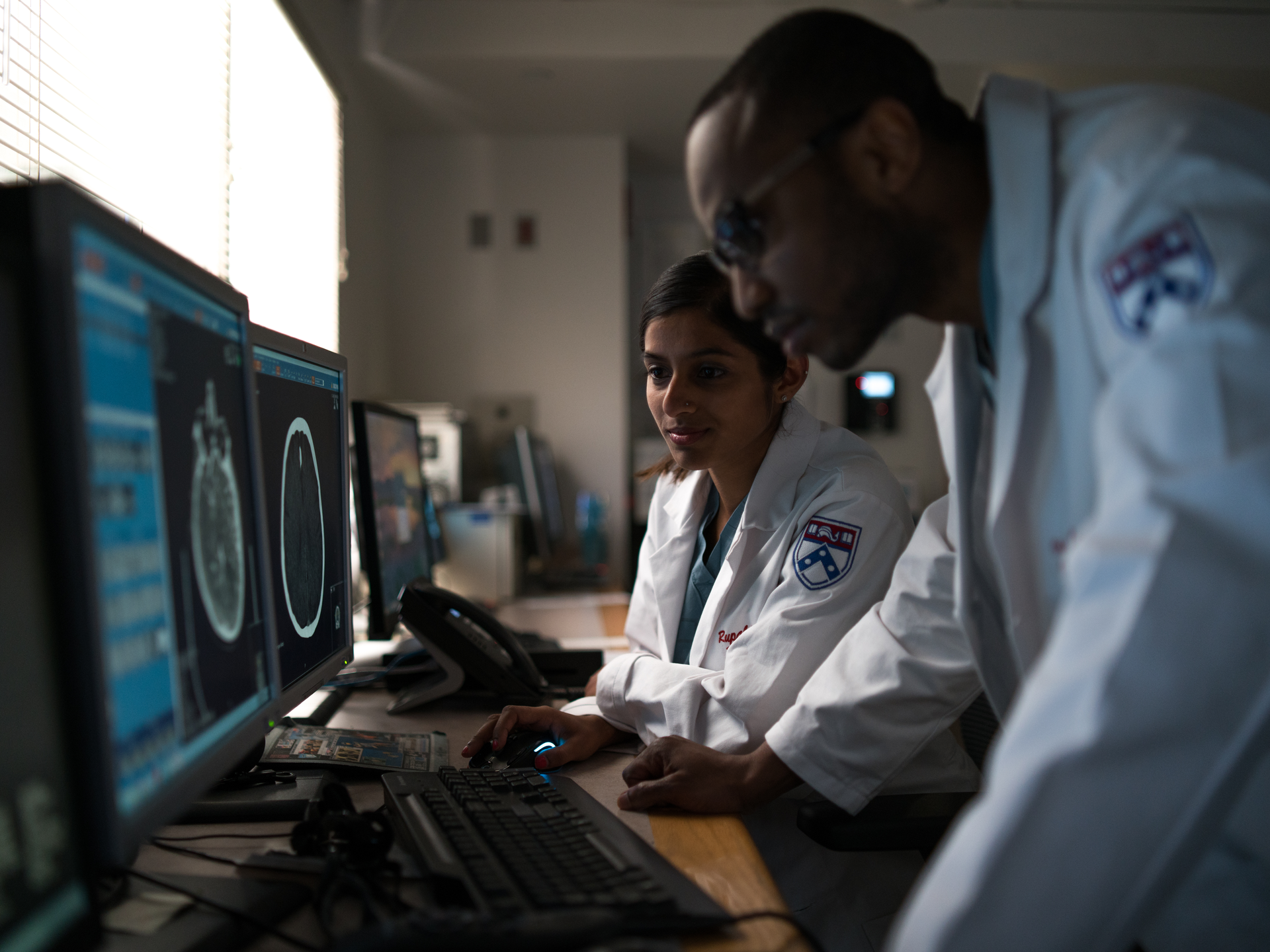 Two Penn Medicine radiologists looking at scan in Nuclear Imaging Room at Perelman Center for Advanced Medicine