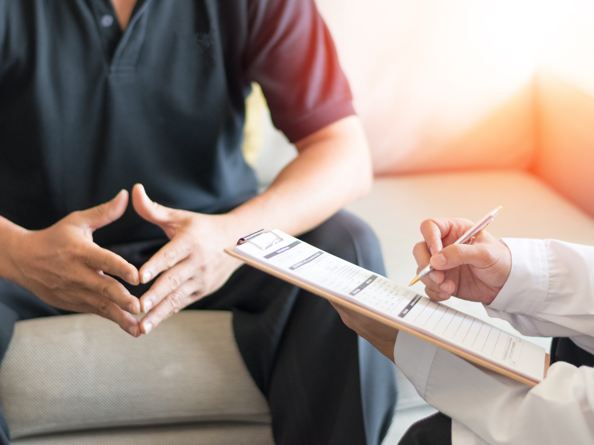 Urology doctor consults with male patient