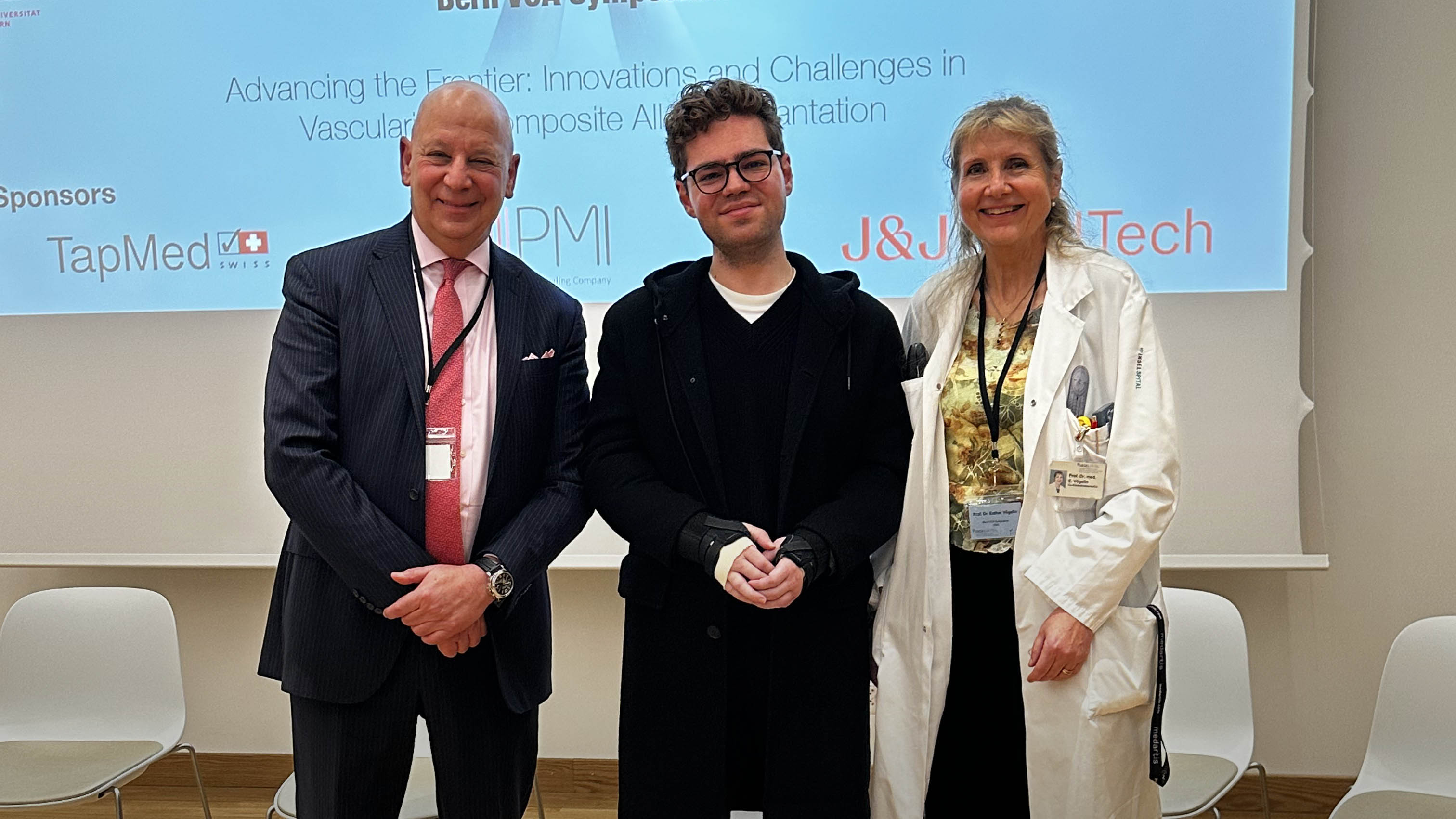 Luka Krizanac with Swiss surgeon Esther Vögelin and Penn Medicine’s Scott Levin in front of a VCA Symposium presentation