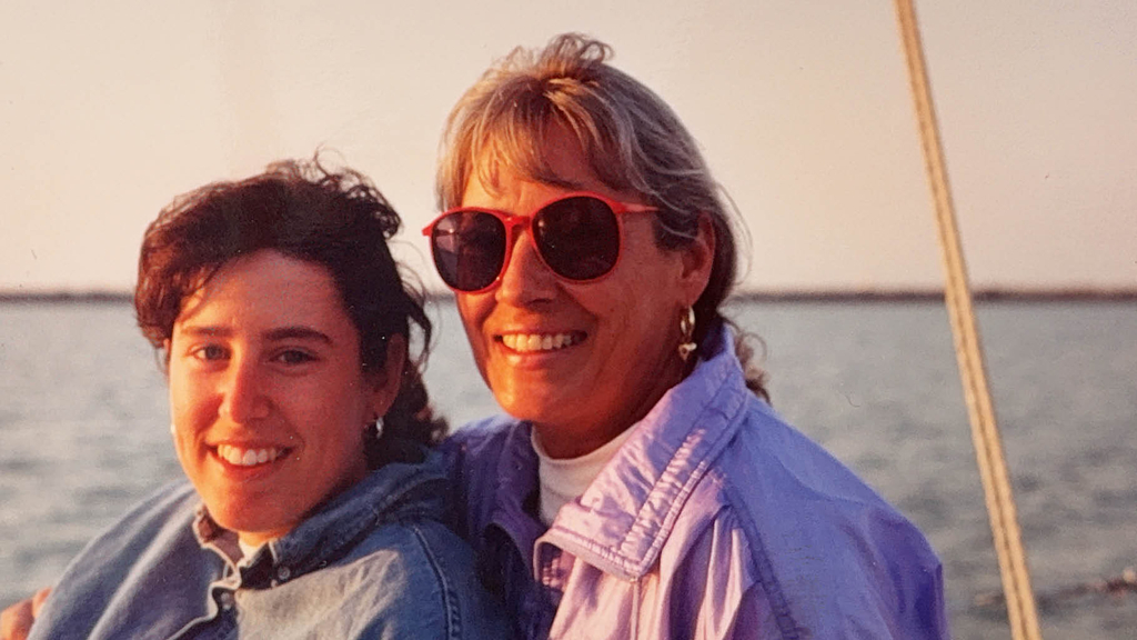 Maggie Gaines as a young woman with her mother, relaxed near water 