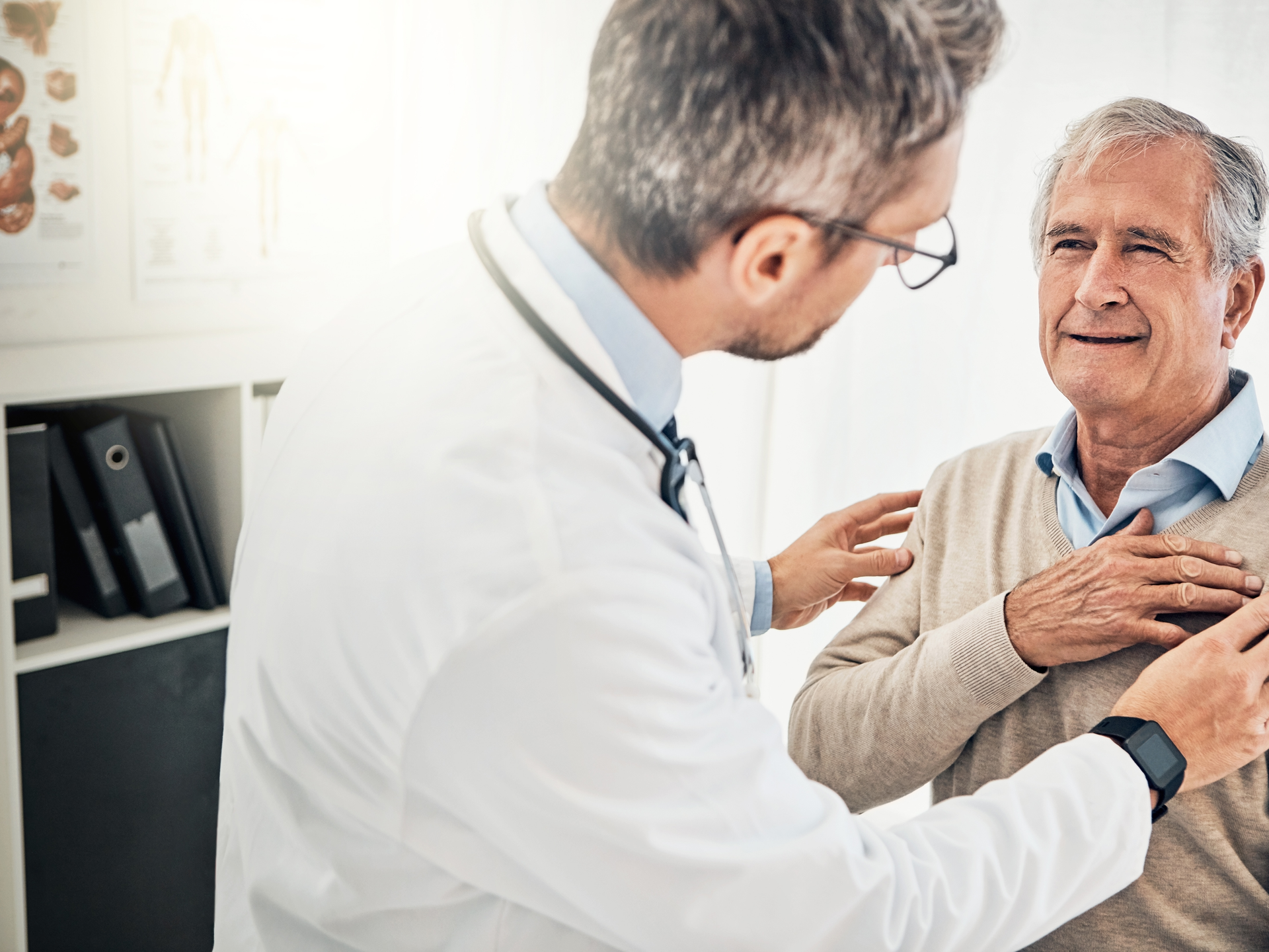 Doctor checking his mature patient's heart during a consultation