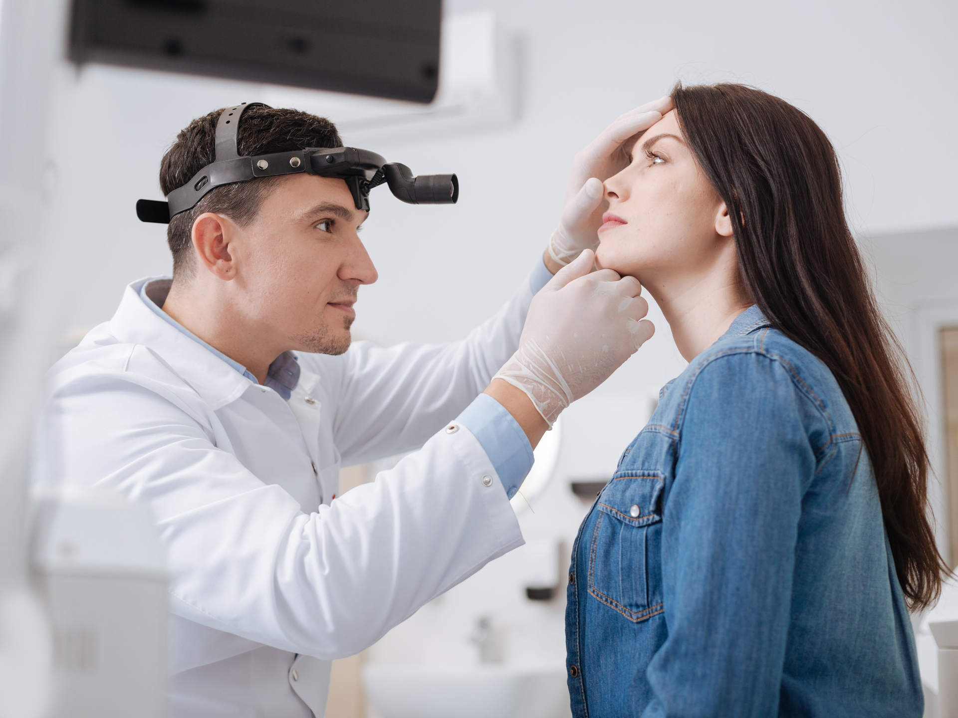 Otolaryngologist working with patient