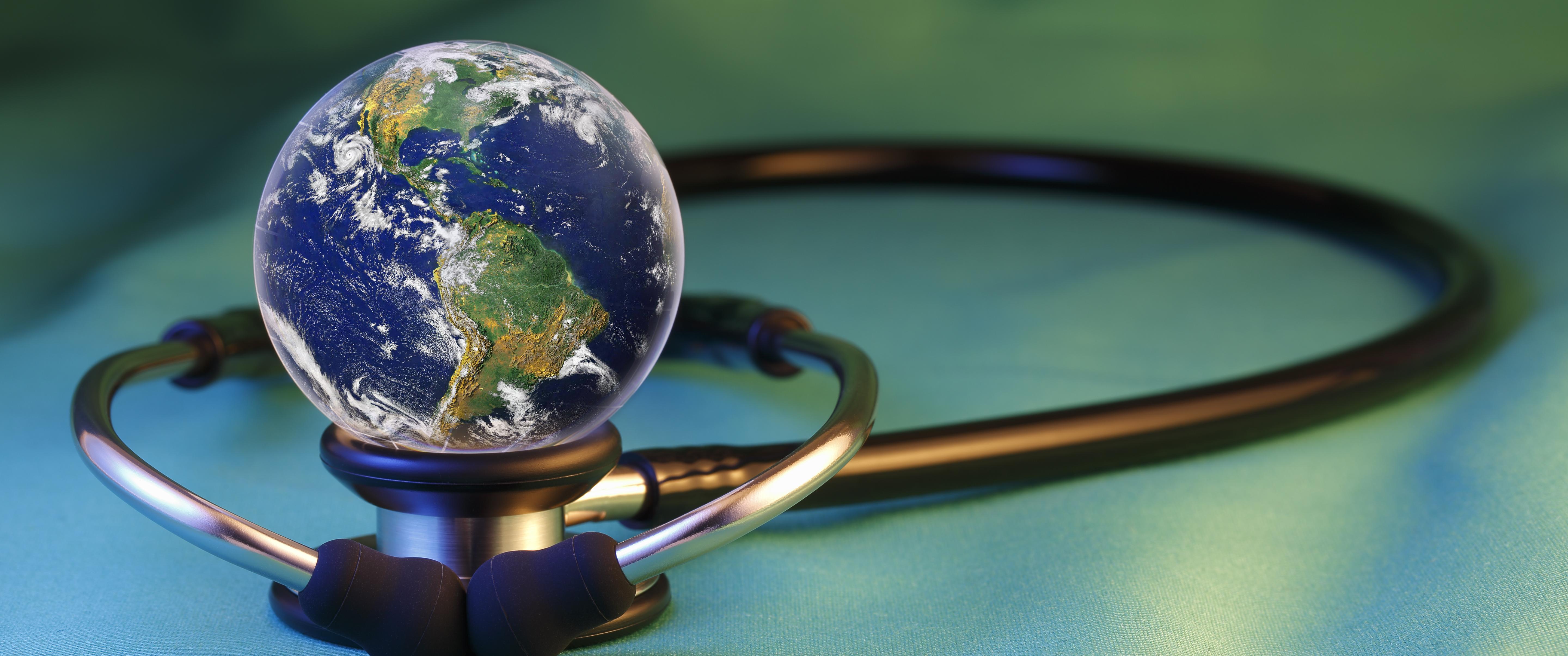 Globe sitting on top of stethoscope, "Elements of earth image courtesy NASA"