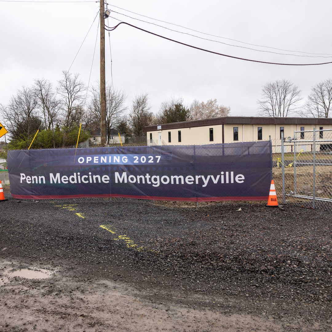 A fenced-in area with a sign displaying Opening 2027 Penn Medicine Montgomeryville