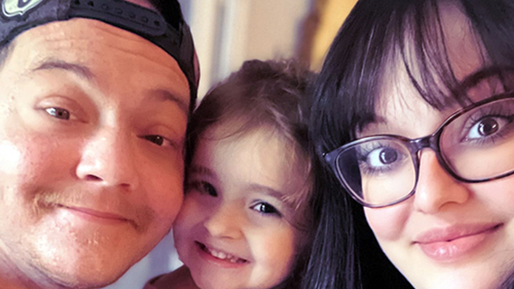 Man with wife and young daughter smile for camera months after ECMO recovery