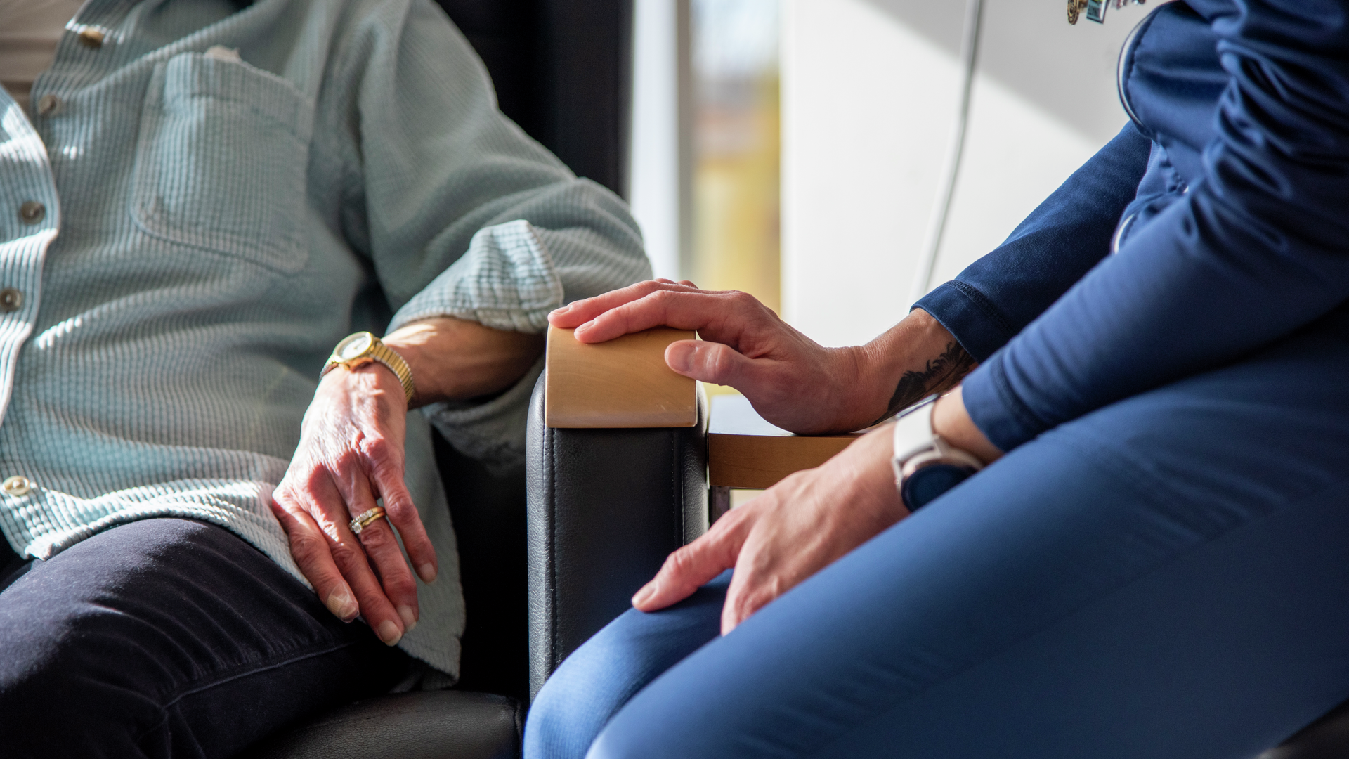 Close up of nurse and patient hands 