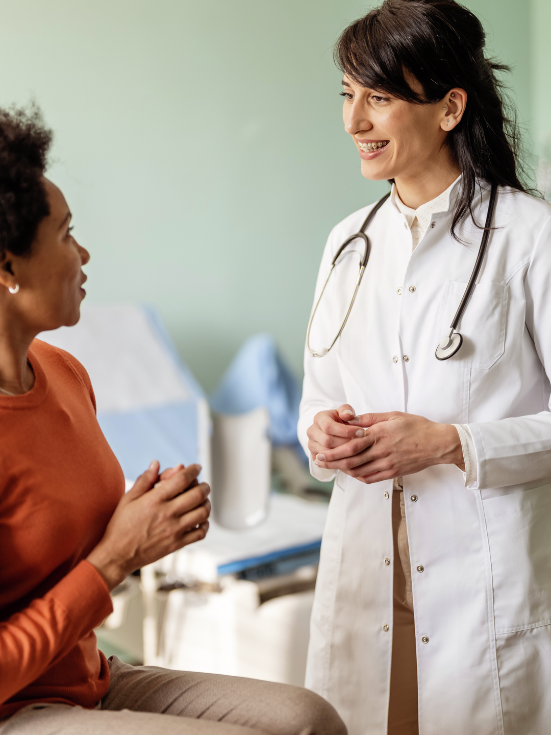 A doctor listens to patient during exam