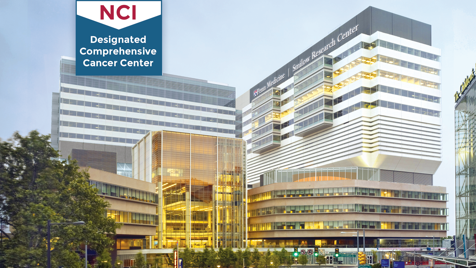 National Cancer Institute "Designated Comprehensive Cancer Center" badge on top of exterior shot of the Perelman Center for Advanced Medicine
