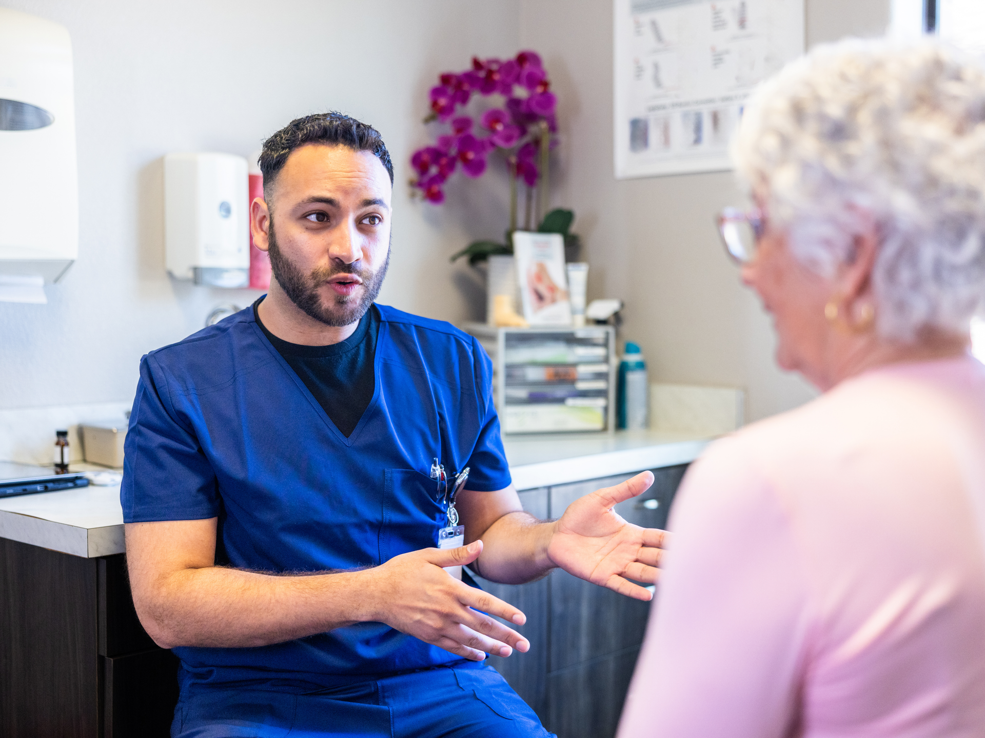Senior consulting with doctor in exam room