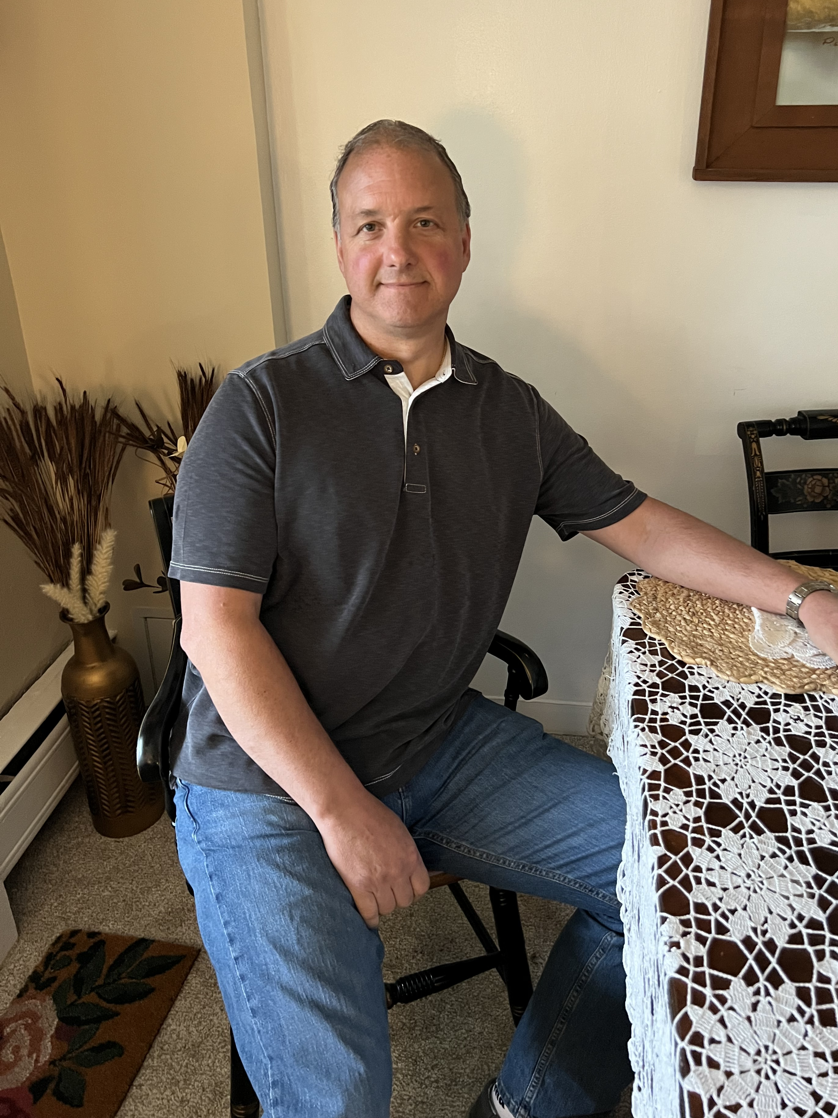 Ed Schumacher, Jr. seated at a dining room table