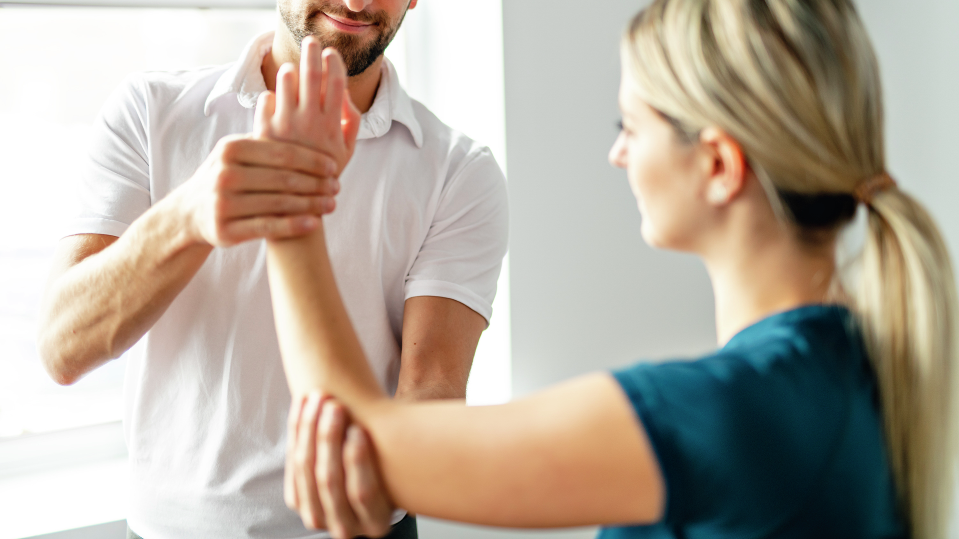 Doctor helping patient rehab hand wrist injury.jpg