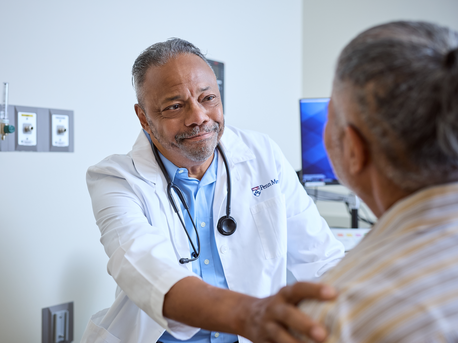 Doctor comforting a patient during a consultation