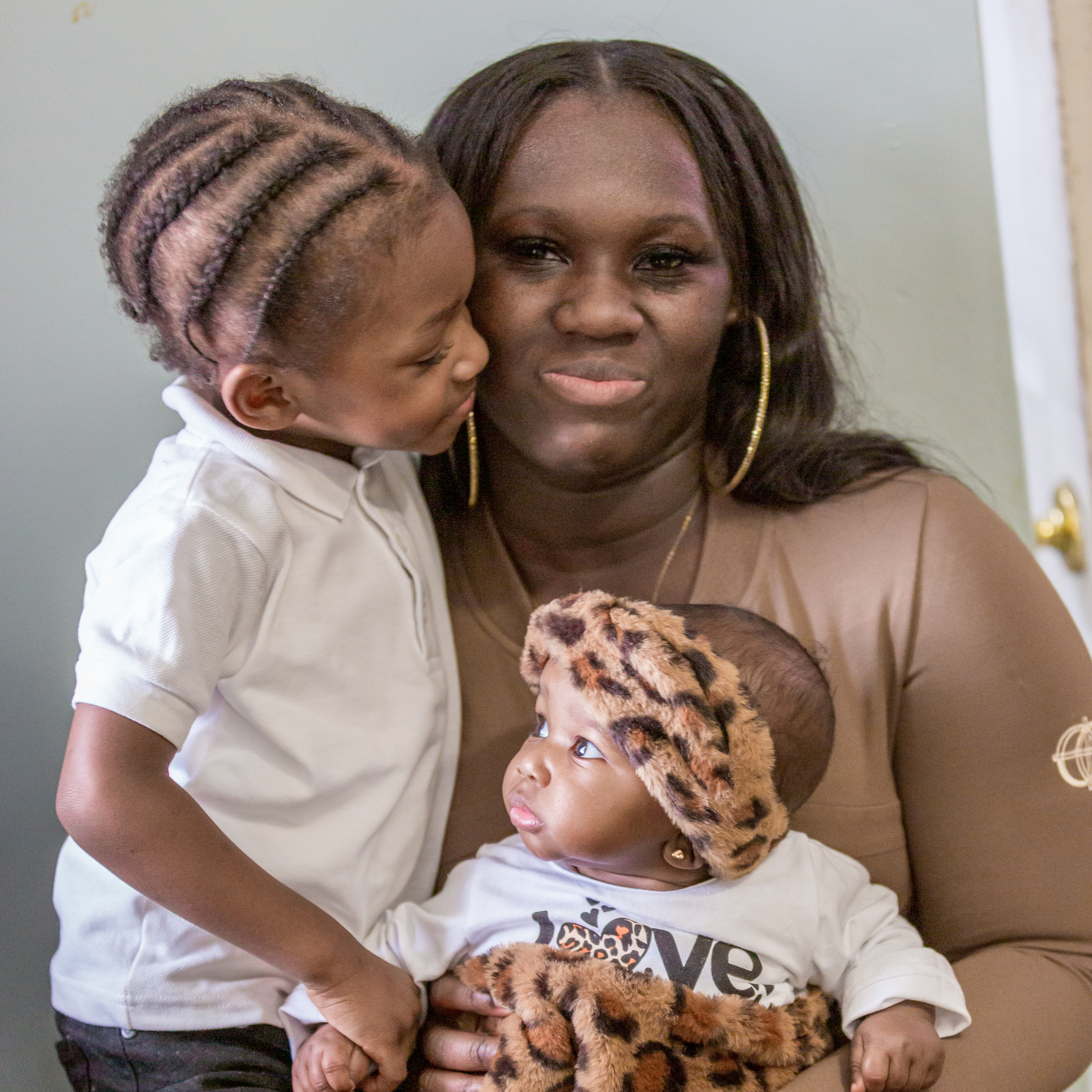 Talicia Williams sits comfortably indoors with son Tayale, 3, and baby daughter Zahiri