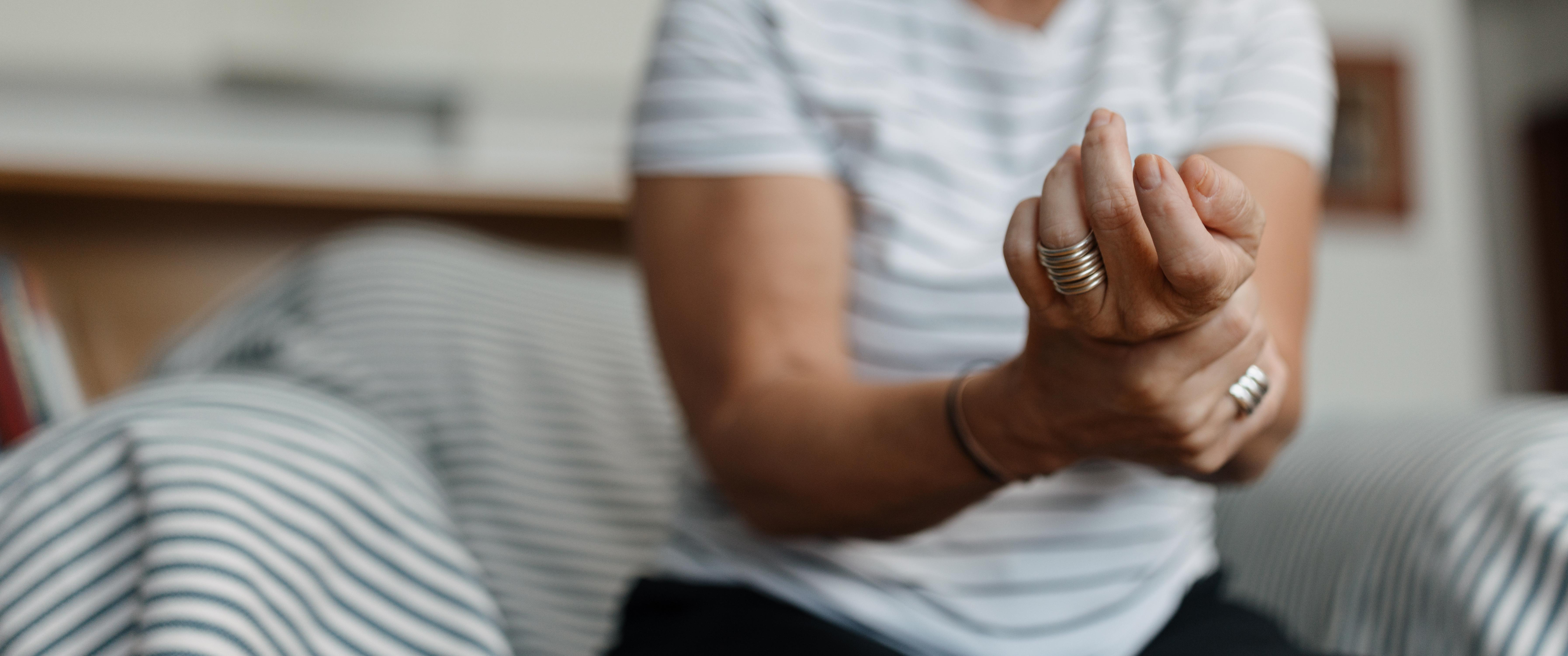 Adult woman having joint pain in her wrist