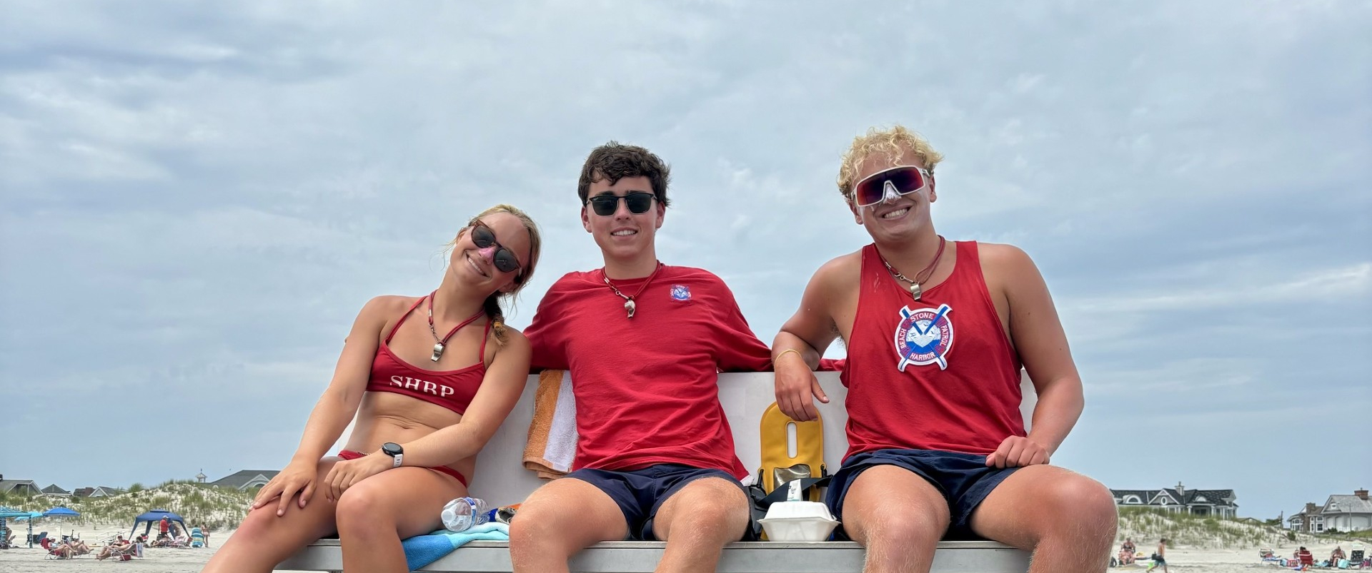 Lifeguards sitting on a lifeguard stand at a beach