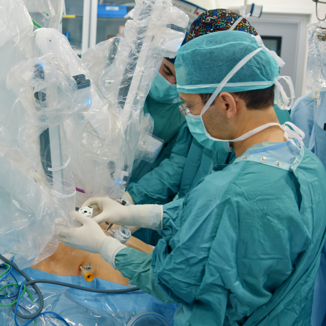 Team of doctors and nurses doing laparoscopic surgery together with the participation of a medical robot