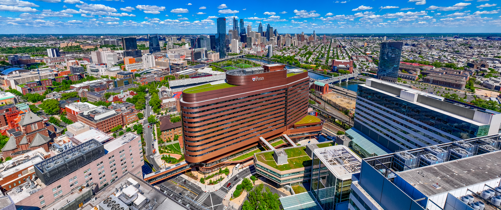 Aerial photo of Philadelphia with HUP and Penn campus buildings in the foreground and the Center City skyline in the distance