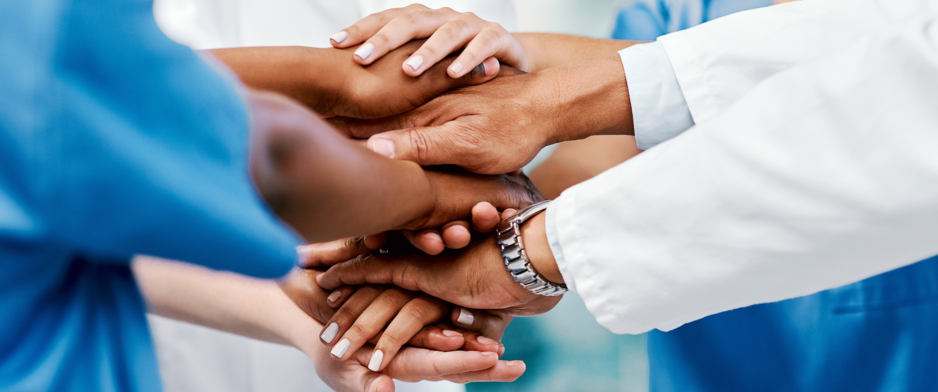 View of hands stacked up