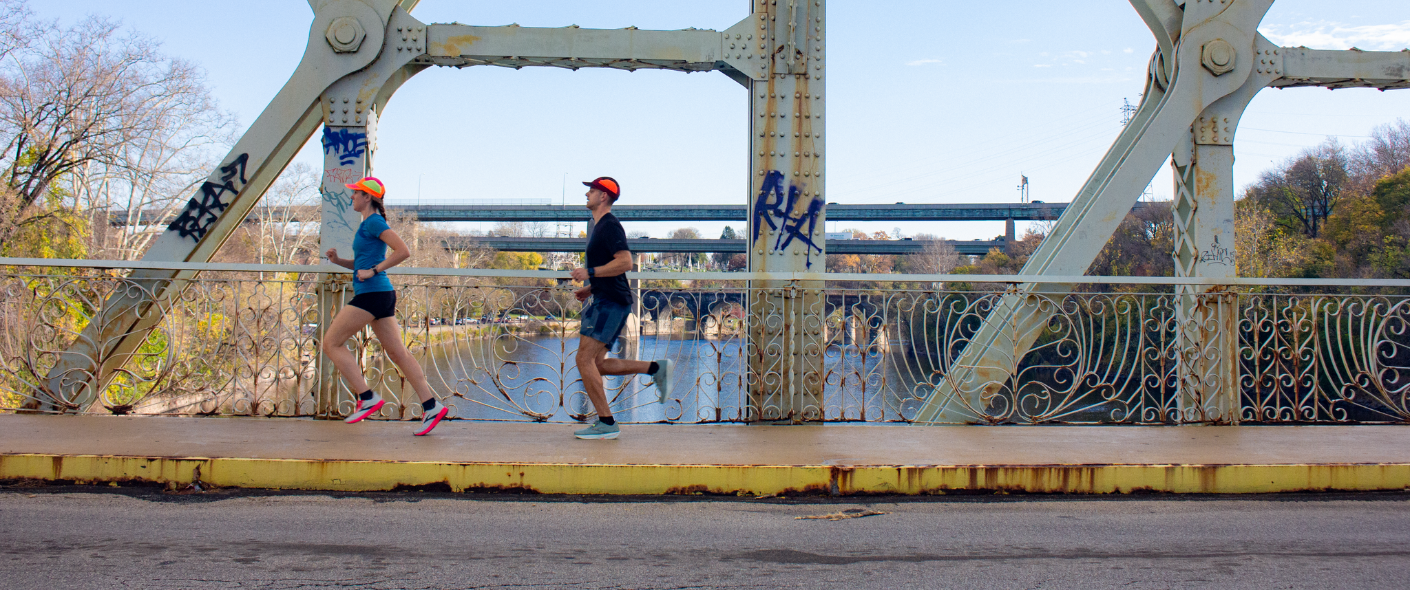 Claire Todd and Eric Todd run across the Falls Bridge in Philadelphia