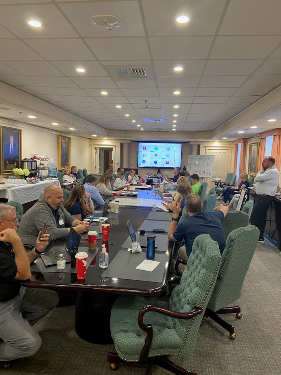 Members of the Chester County Hospital command center sit at a long conference table