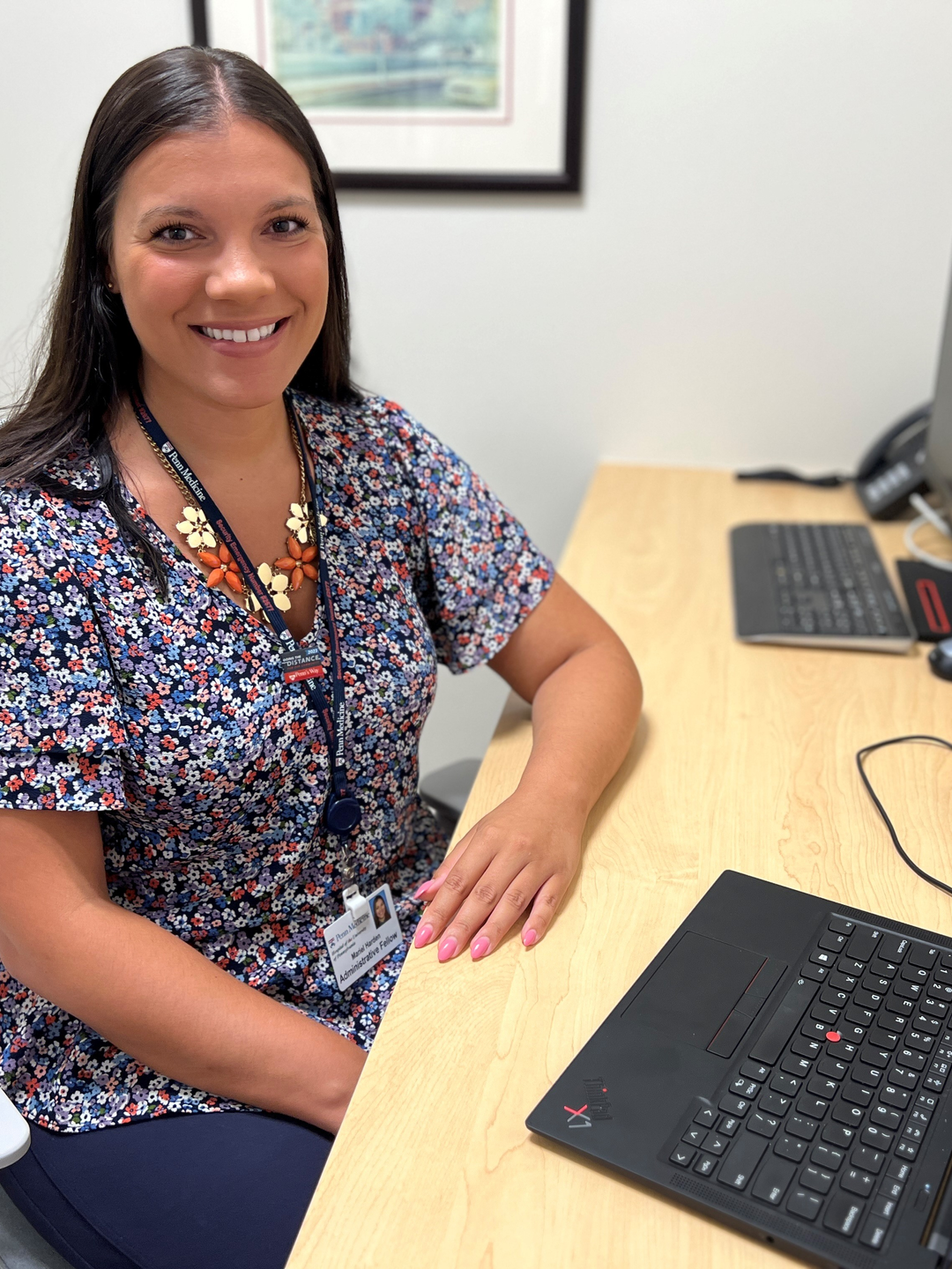 Mariel Harden seated at a desk in front of a laptop