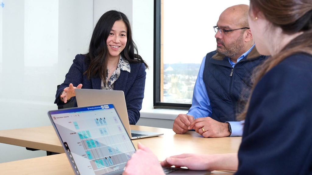 Kat Lee and Mohan Balachandran meet at a conference table