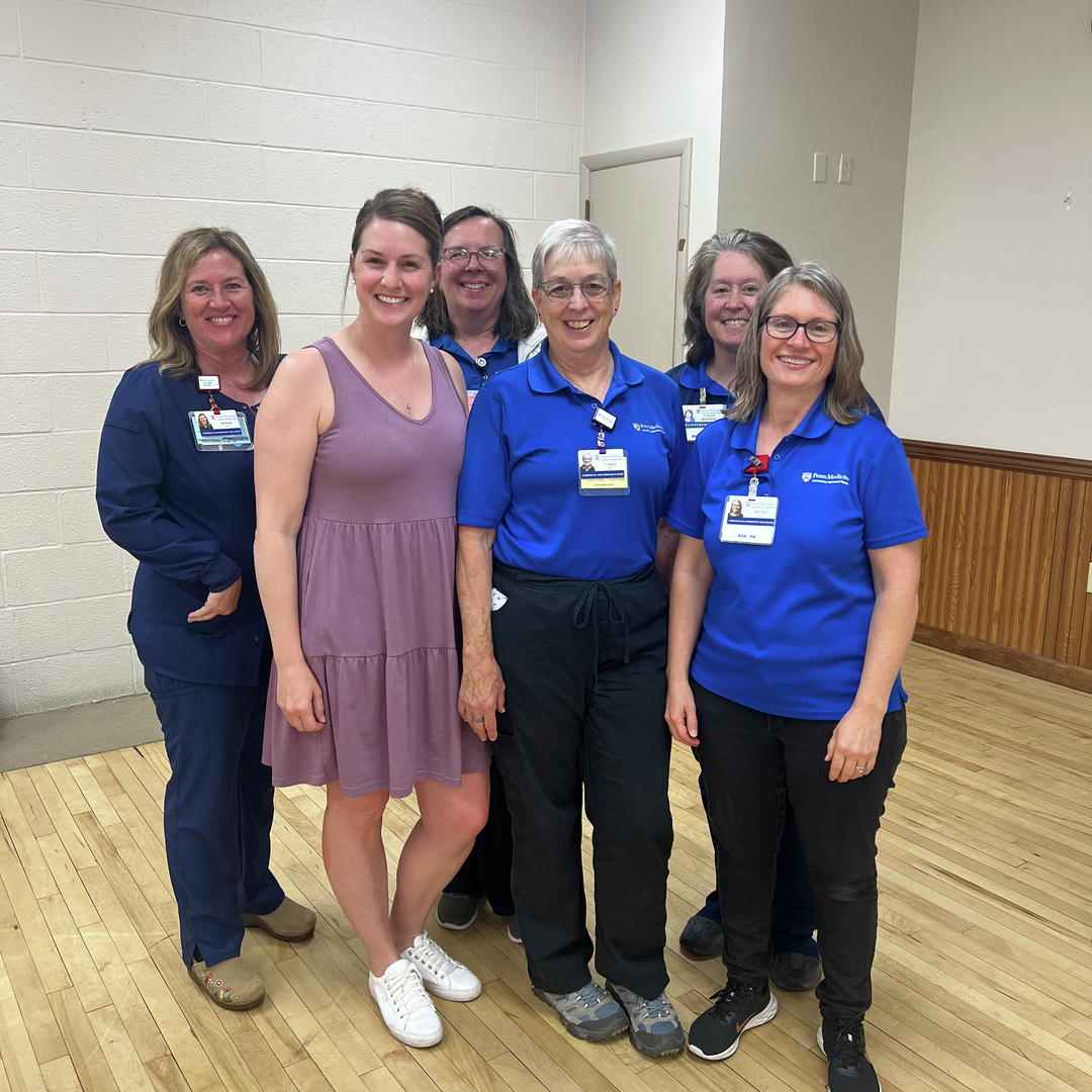 A group shot of ChildProtect nurses gathering and smiling at the Witmer Fire Hall vaccine clinic.