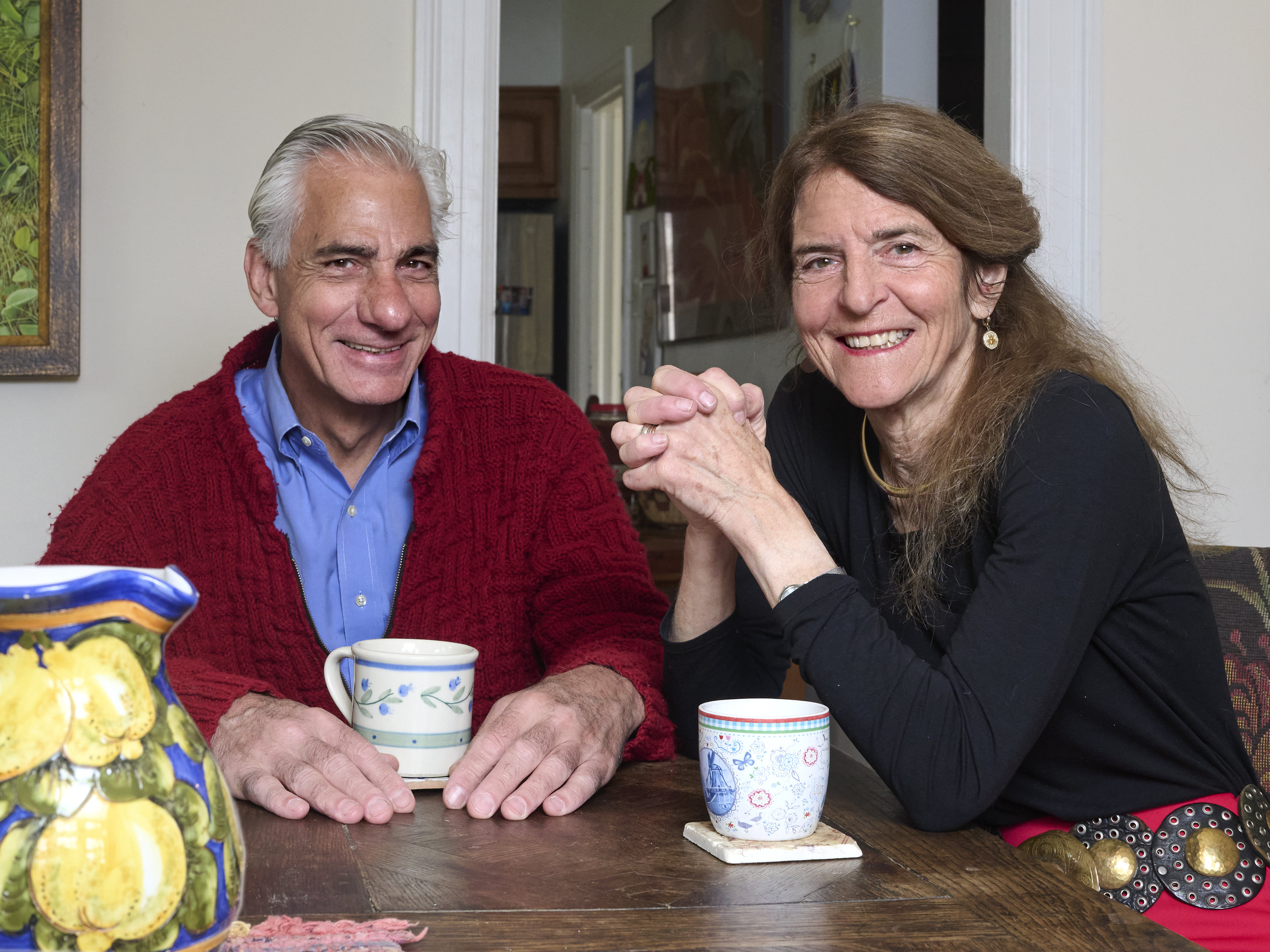 Albert Maguire and Jean Bennett sitting at a table with coffee mugs