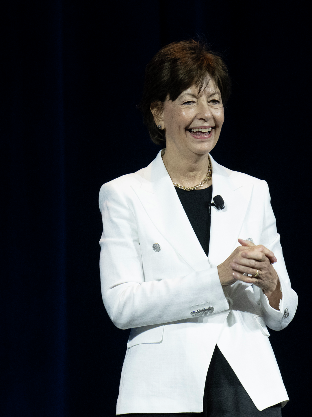 Lynn Schuchter, MD, on stage at ASCO, smiling
