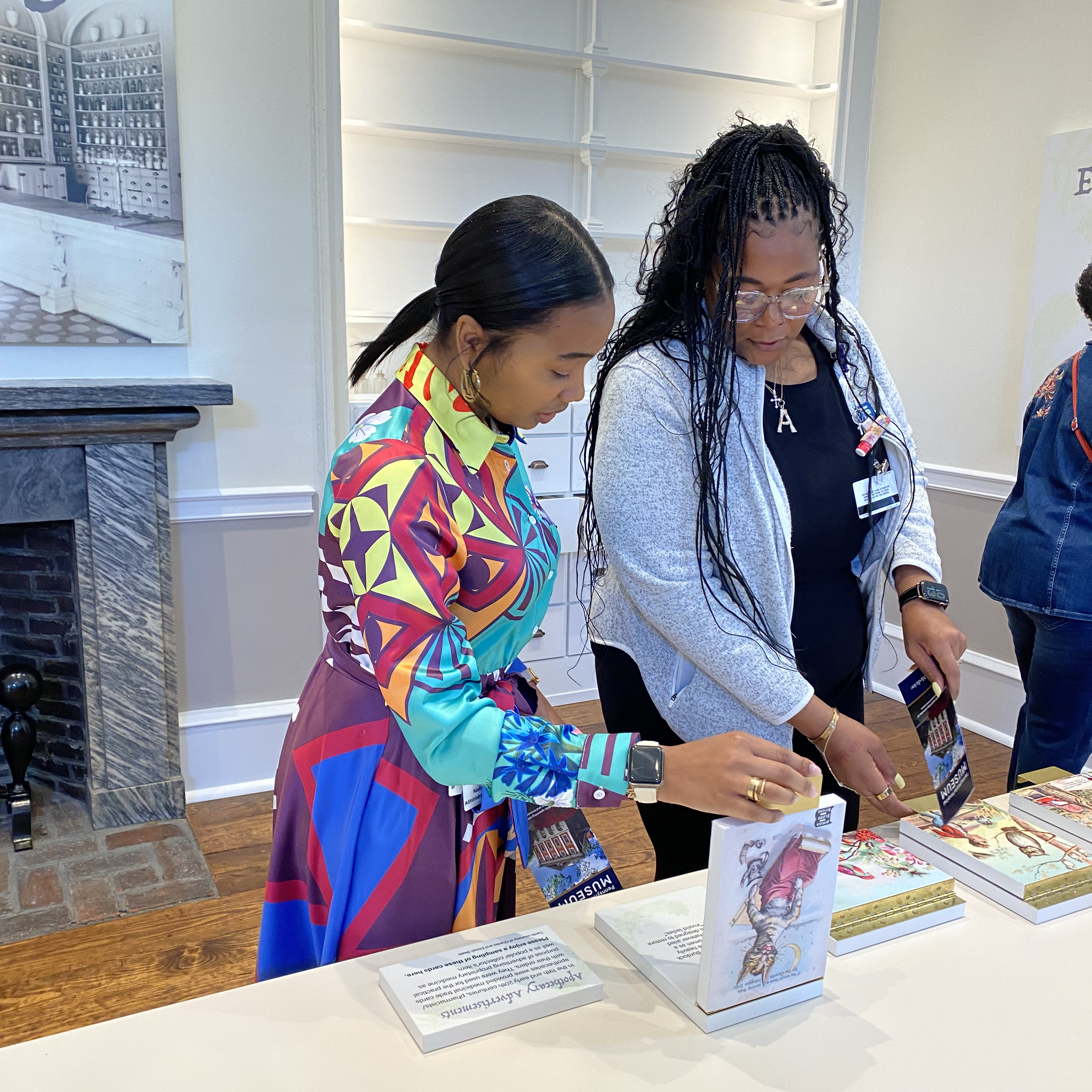 Nashai Berry-Hill and Ashley Brandon-Brown interacting with an apothecary exhibit at the Pennsylvania Hospital Museum