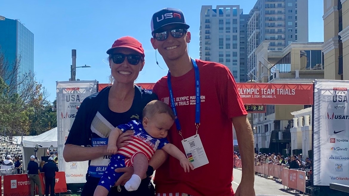 Katie Florio with her husband and baby son wearing running gear and patriotic colors