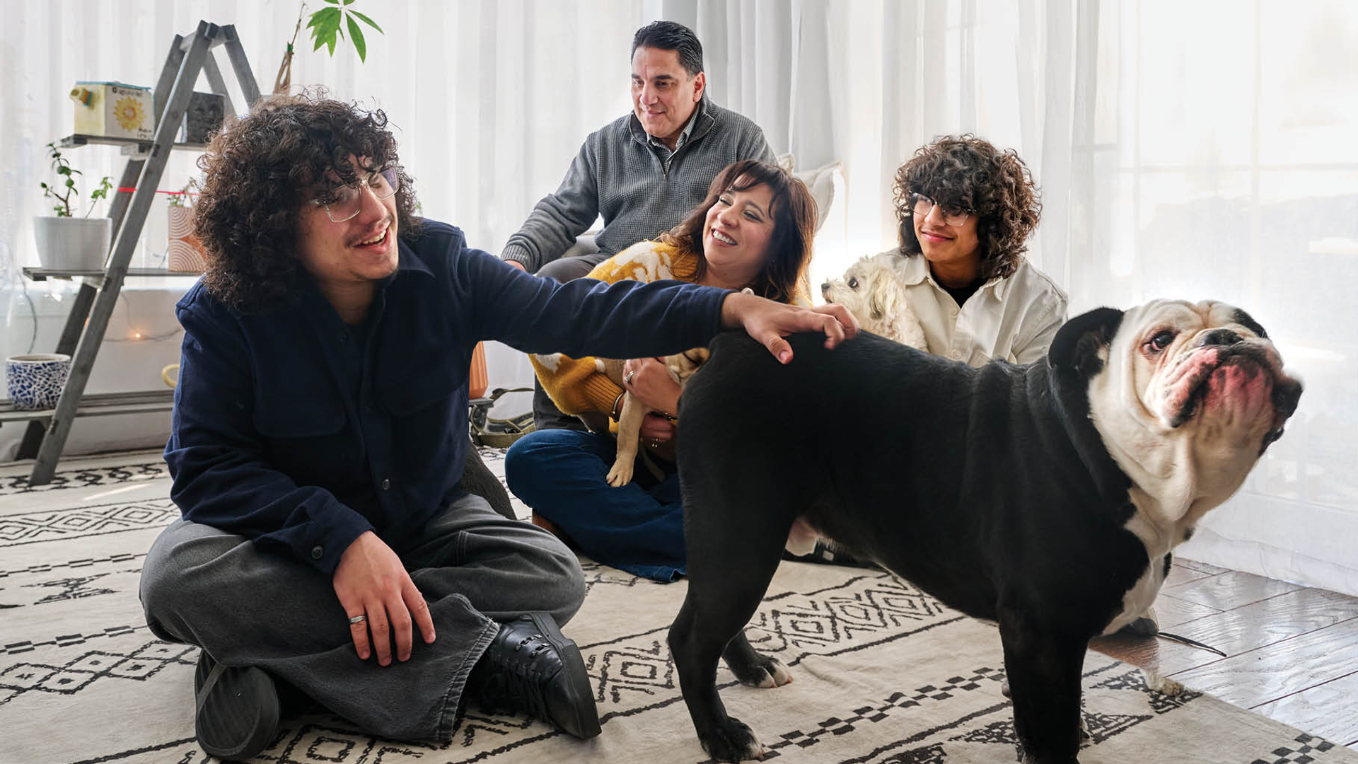 Illeana Casiano Vazquez, with her husband, two teenage sons, and three dogs, in a relaxed moment at home 
