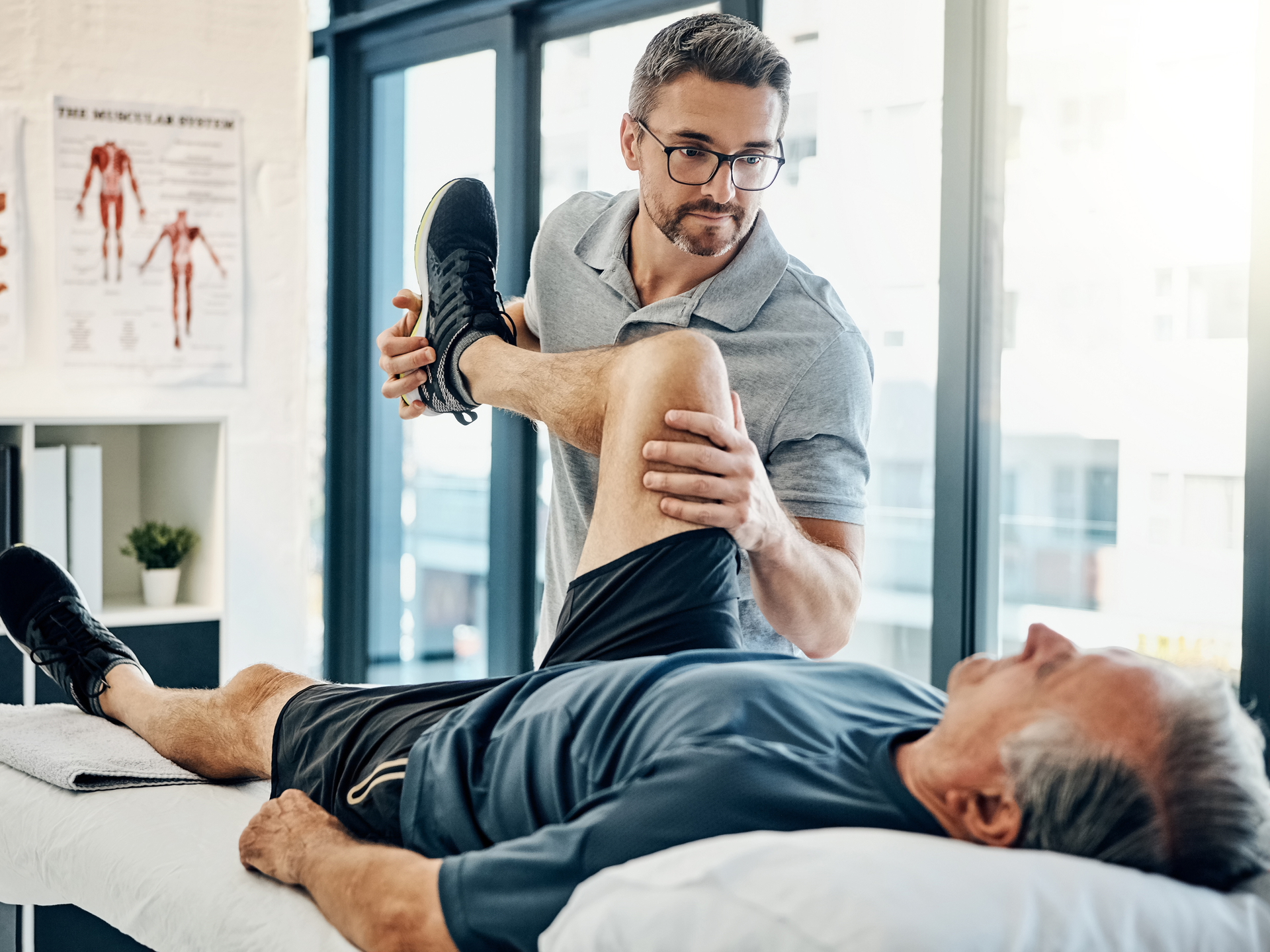 Shot of a friendly physiotherapist treating his mature patient in a rehabilitation center