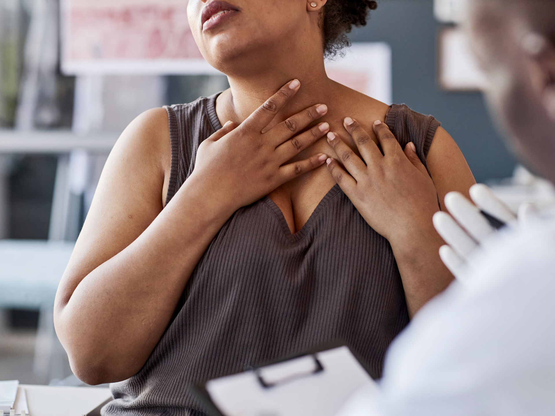 Cropped shot of adult African American woman talking to doctor and demonstrating skin rash