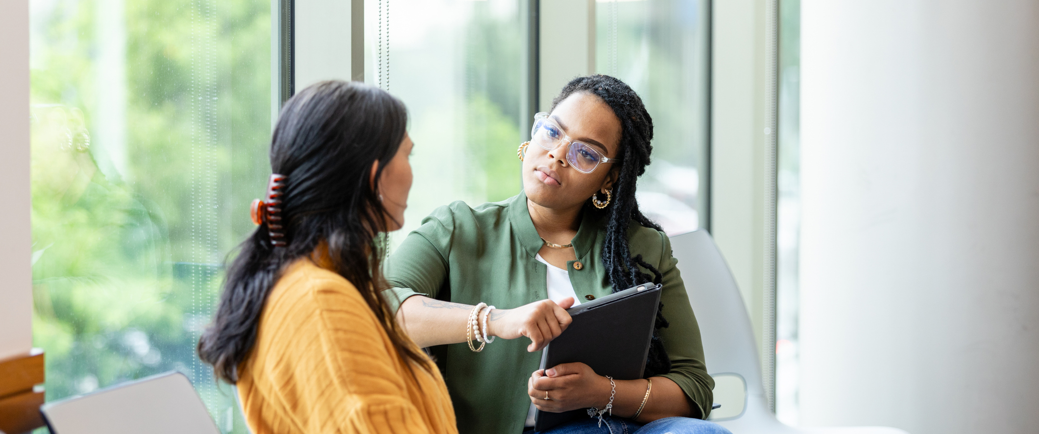 An empathetic female counselor listens as a vulnerable patient shares about a difficult situation.