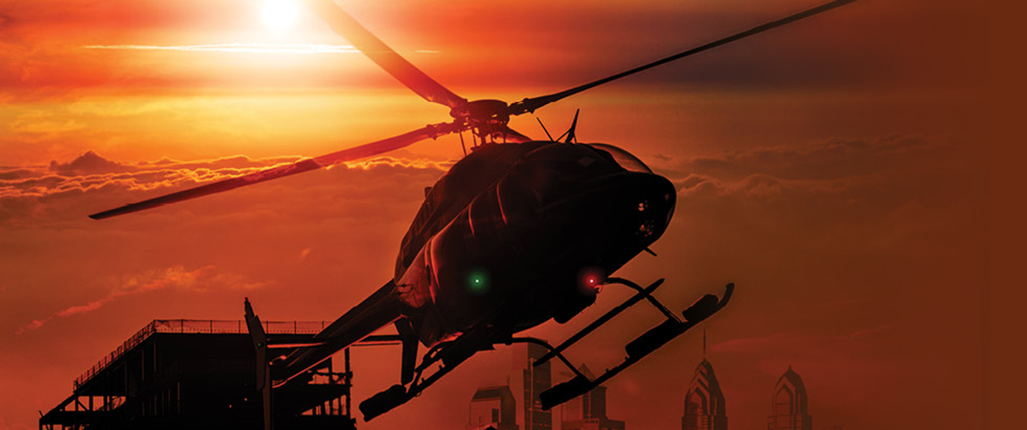 The PennSTAR medical helicopter takes off against a red-orange sky background
