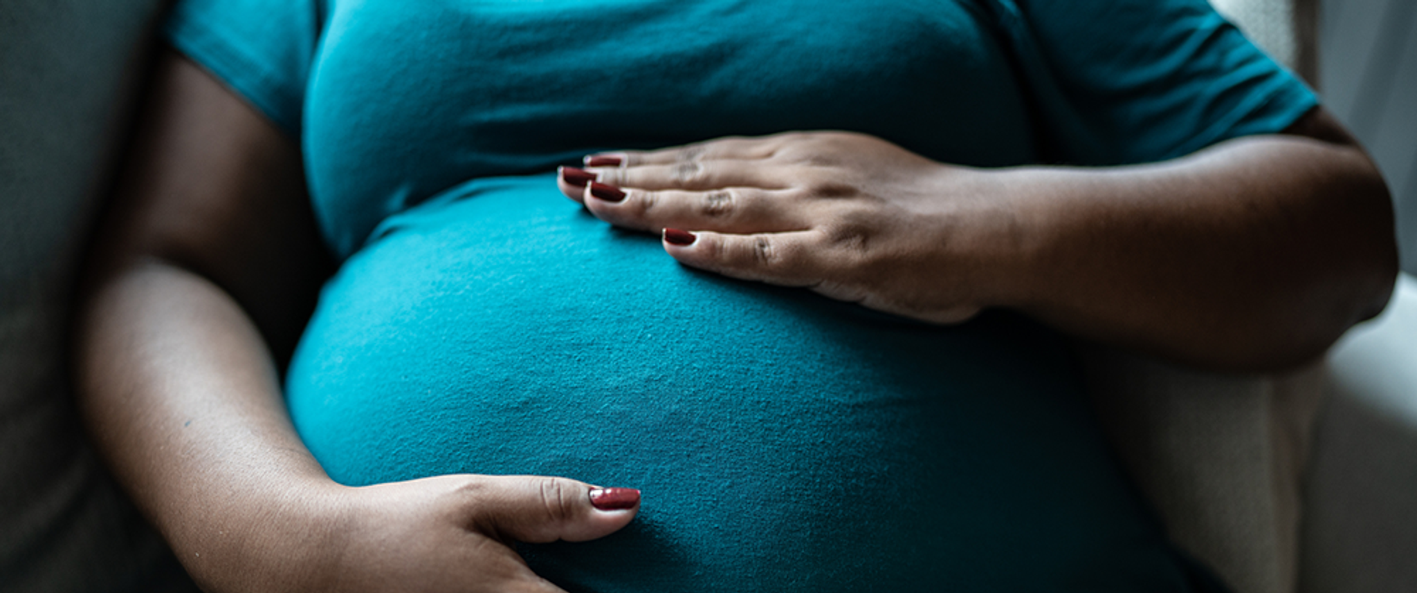 Pregnant woman touching her belly